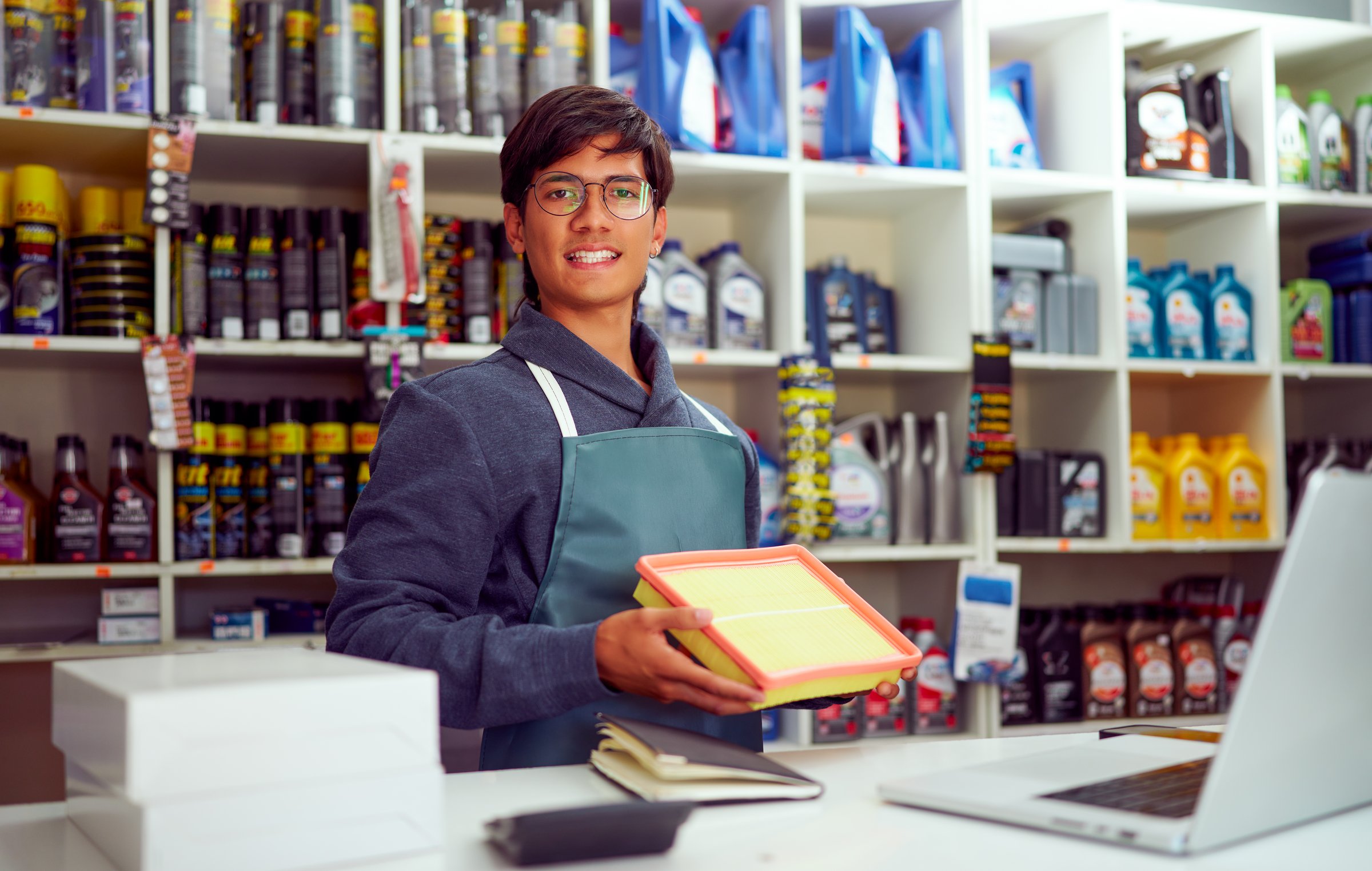 Employee arranging products in automotive supply store