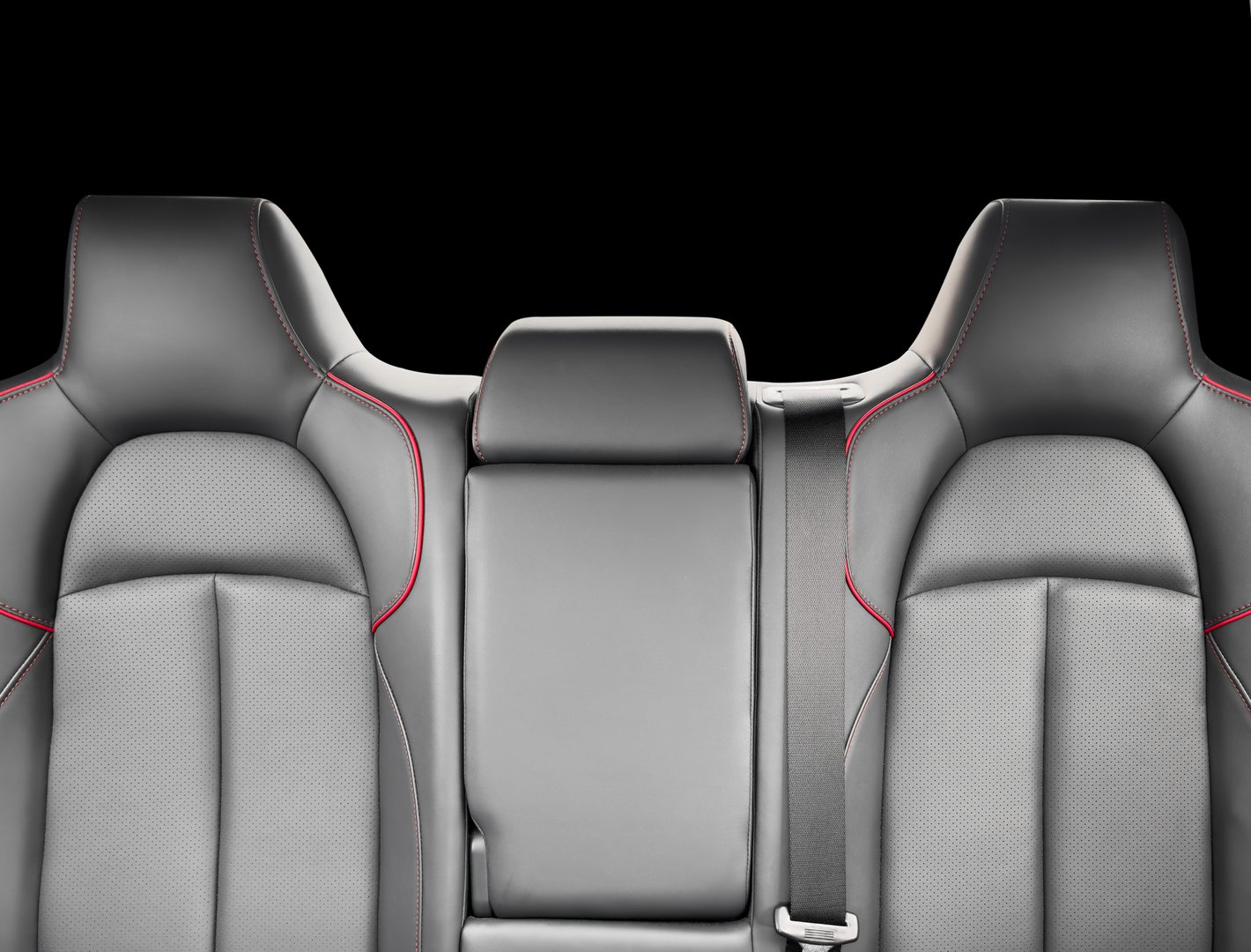 Back passenger black seats in modern luxury car. Black perforated leather with white stitching. Car details. Leather comfortable seats. Car interior details