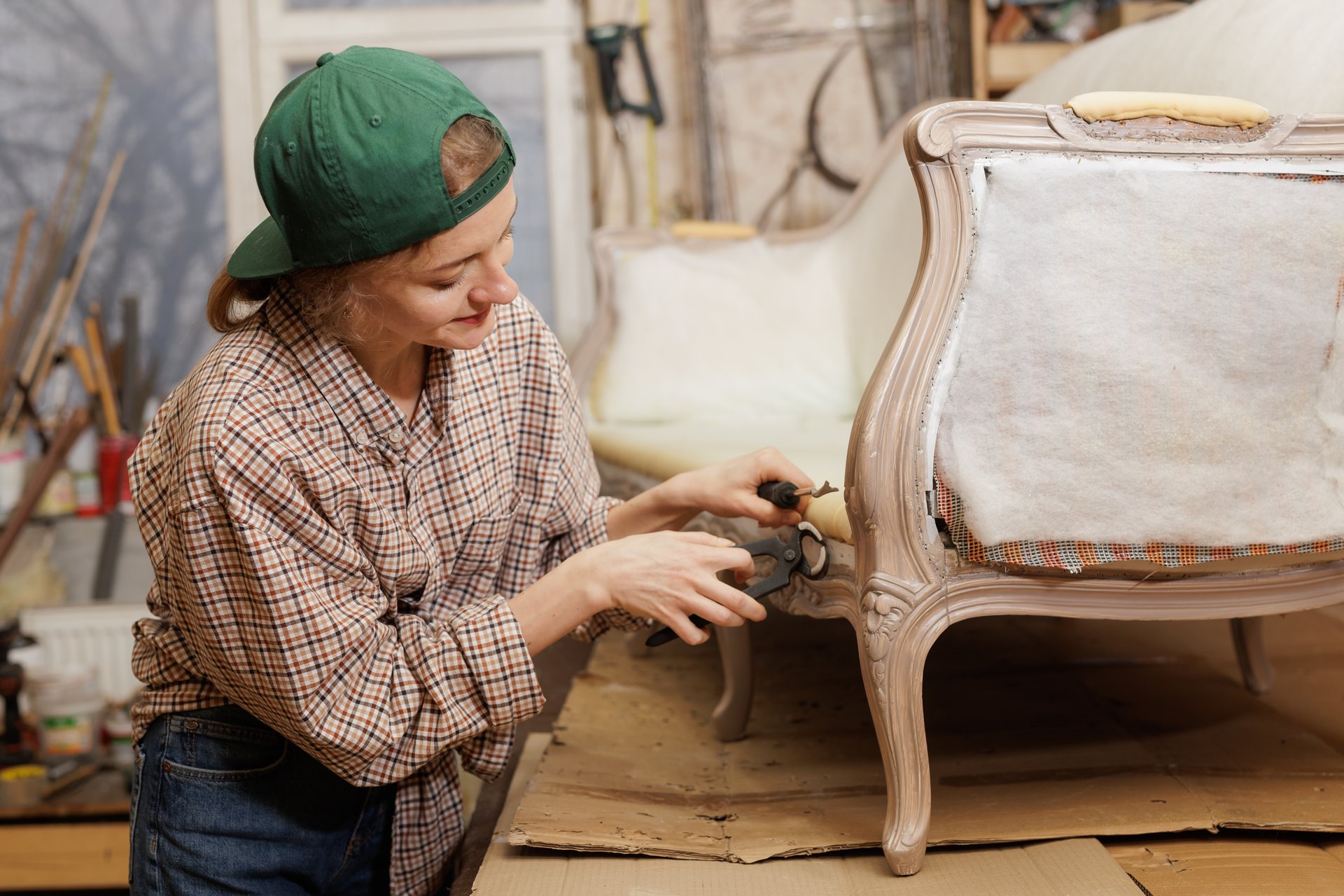 woman is engaged in restoration and decoration of an old vintage sofa. furniture repair