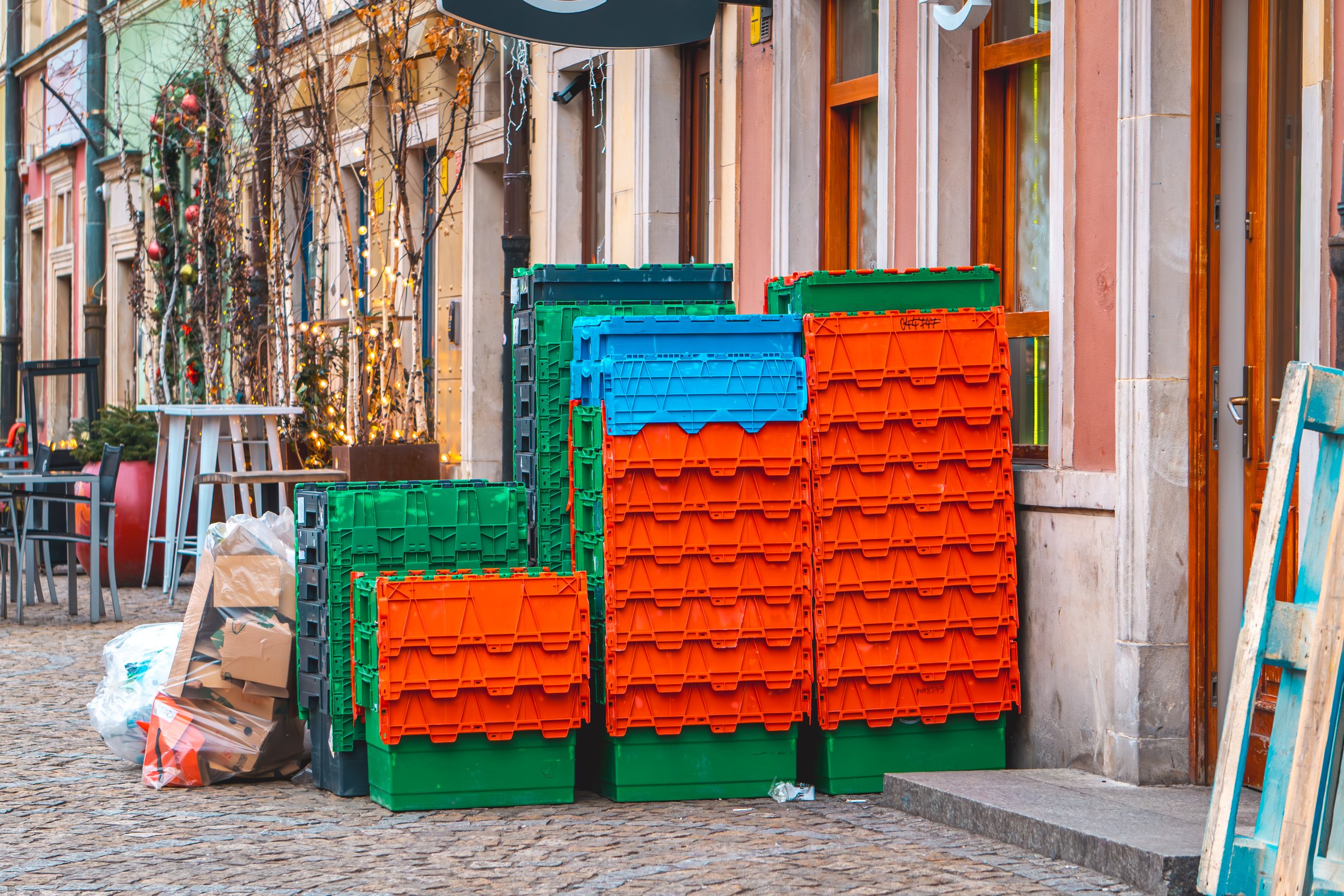plastic boxes in front of the store after the delivery of food. garbage and cardboard boxes lying outside the store.