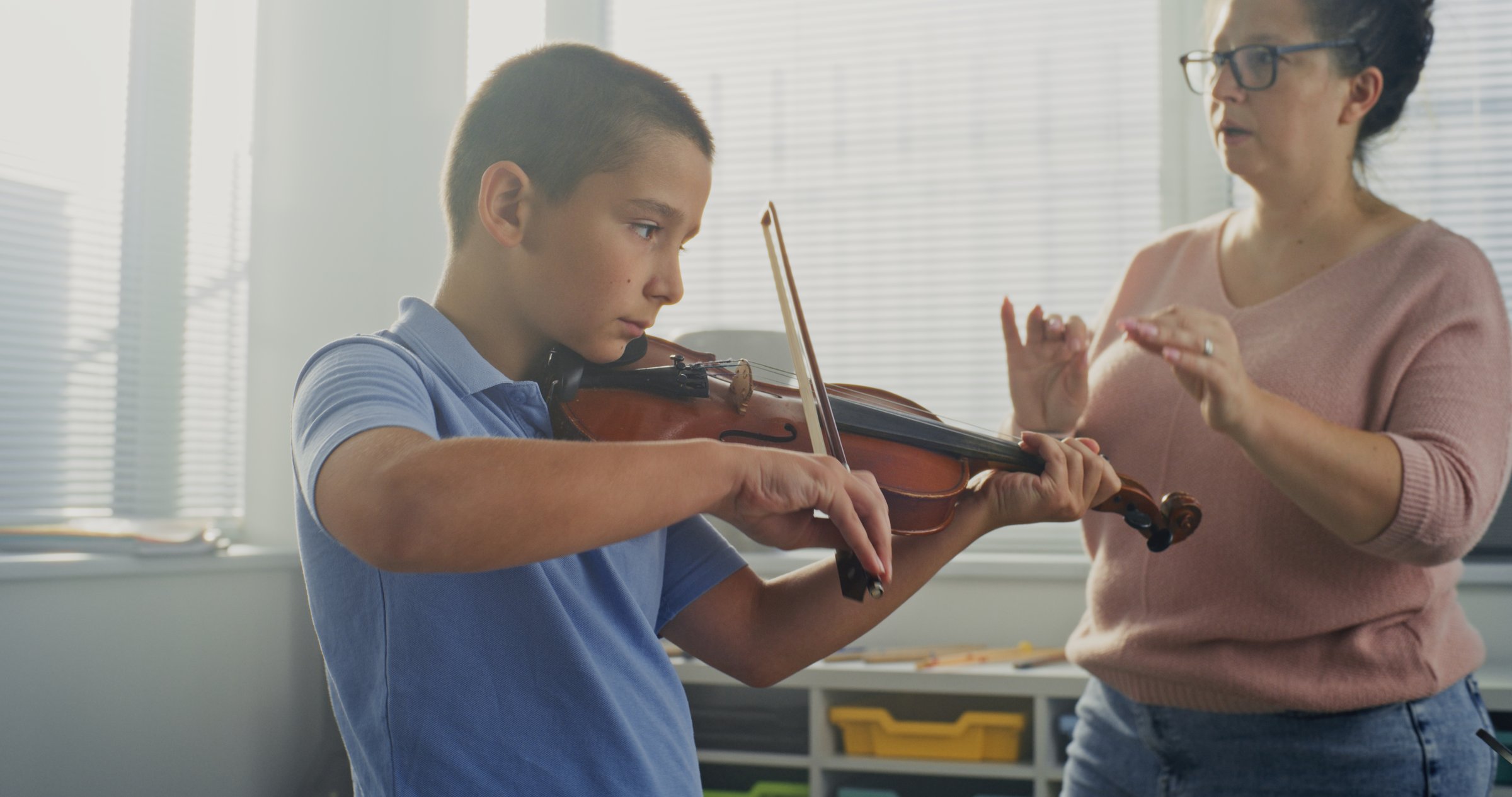 Primary School Boy Practicing Violin in Music Class, Dreaming to Become Musician. Teacher Guiding Artistic Child in Playing Musical Instrument. Musical Education, Violin Training Lesson, Rehearsal.