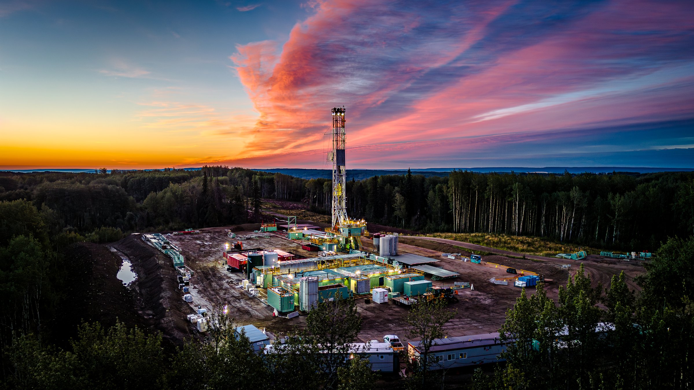 Drone photo of sunrise over a drilling rig in Alberta Canada