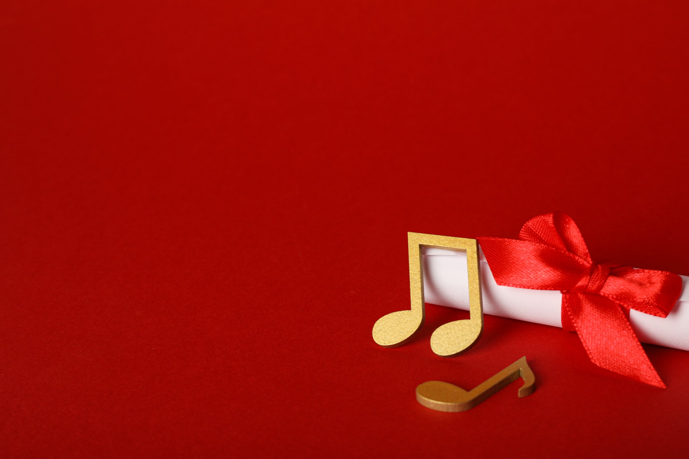 Golden notes with a scroll on a red background