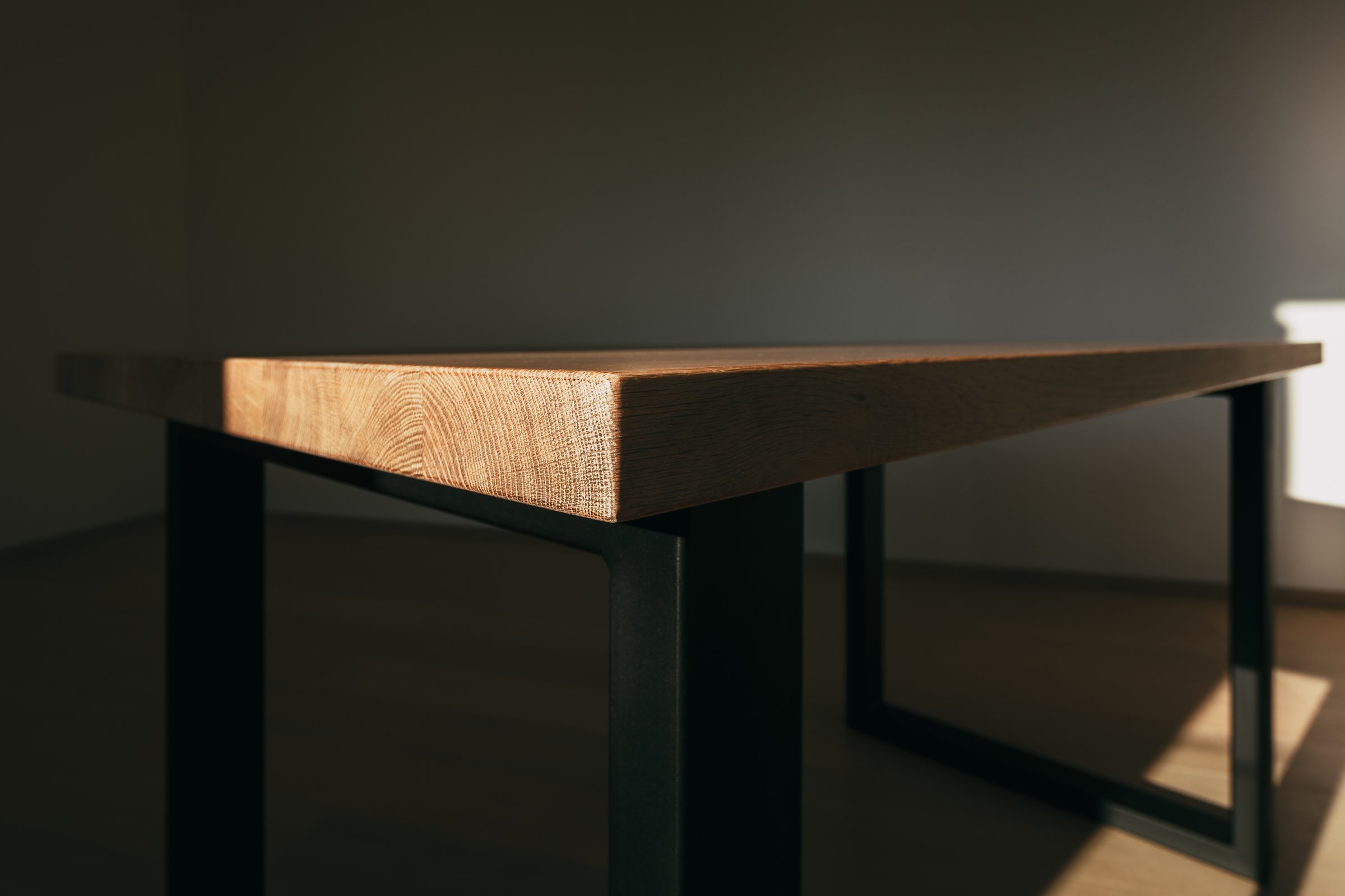 Detailed texture of modern wooden table and angular iron structures in form of legs on sides