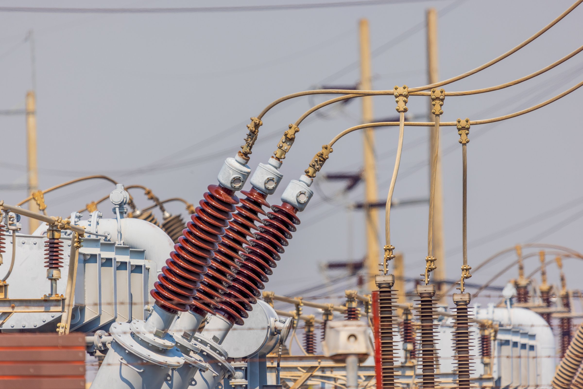 High voltage ceramic insulators on towers in Power Substation.