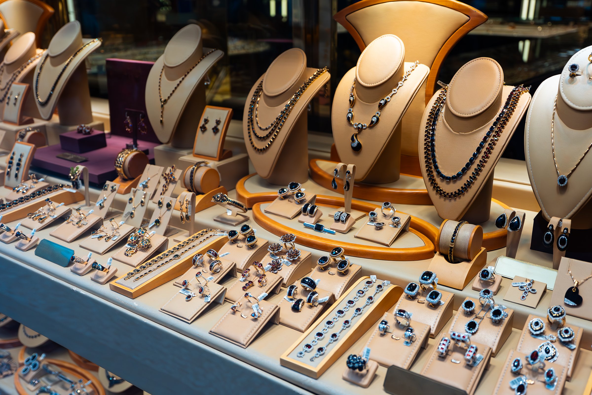 Luxury jewelry display with necklaces and rings.