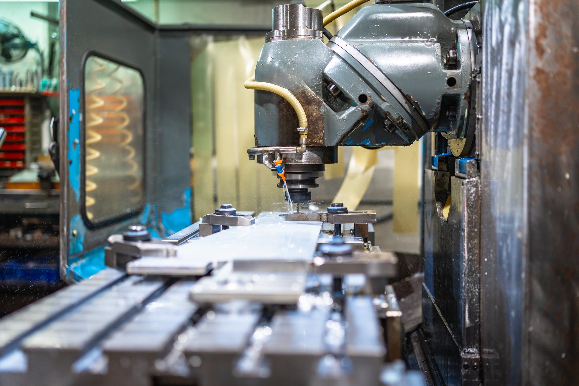 Milling machine molding shapes in metal pieces in a cnc factory with no people