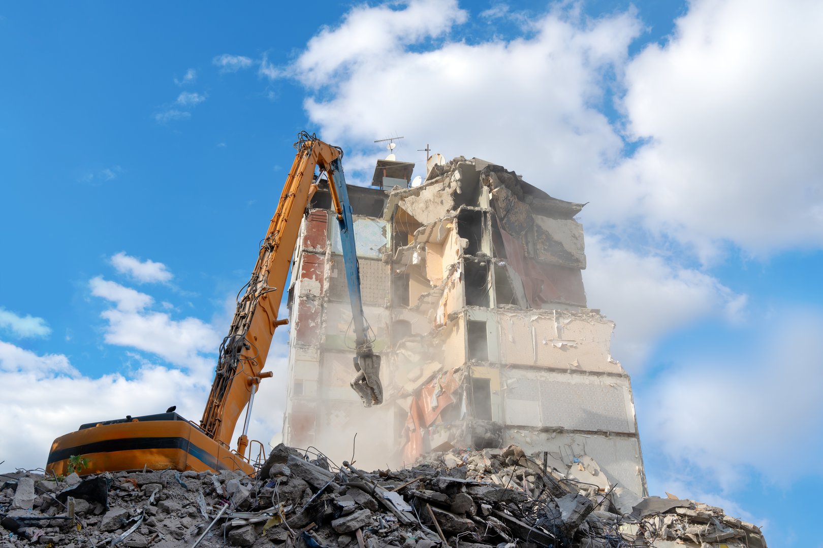 Industrial demolition using heavy machinery. Demolition of old residential buildings using specialized equipment.