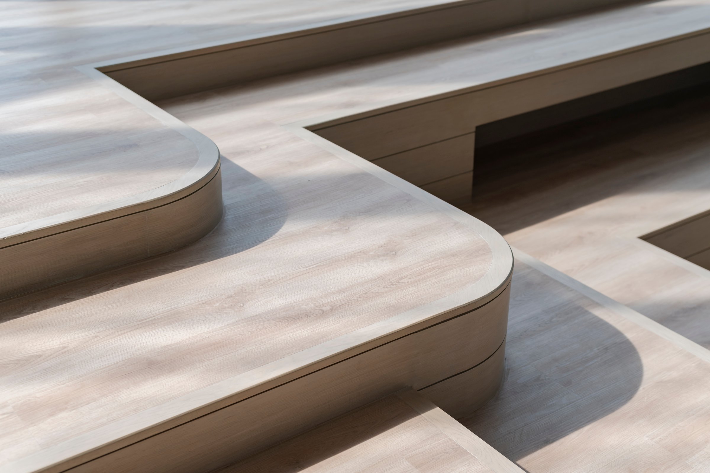 Wooden stairs with curved corners in a modern house interior