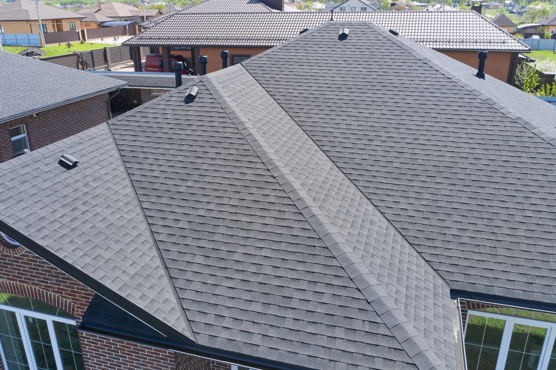 Luxury house roof with asphalt shingles.