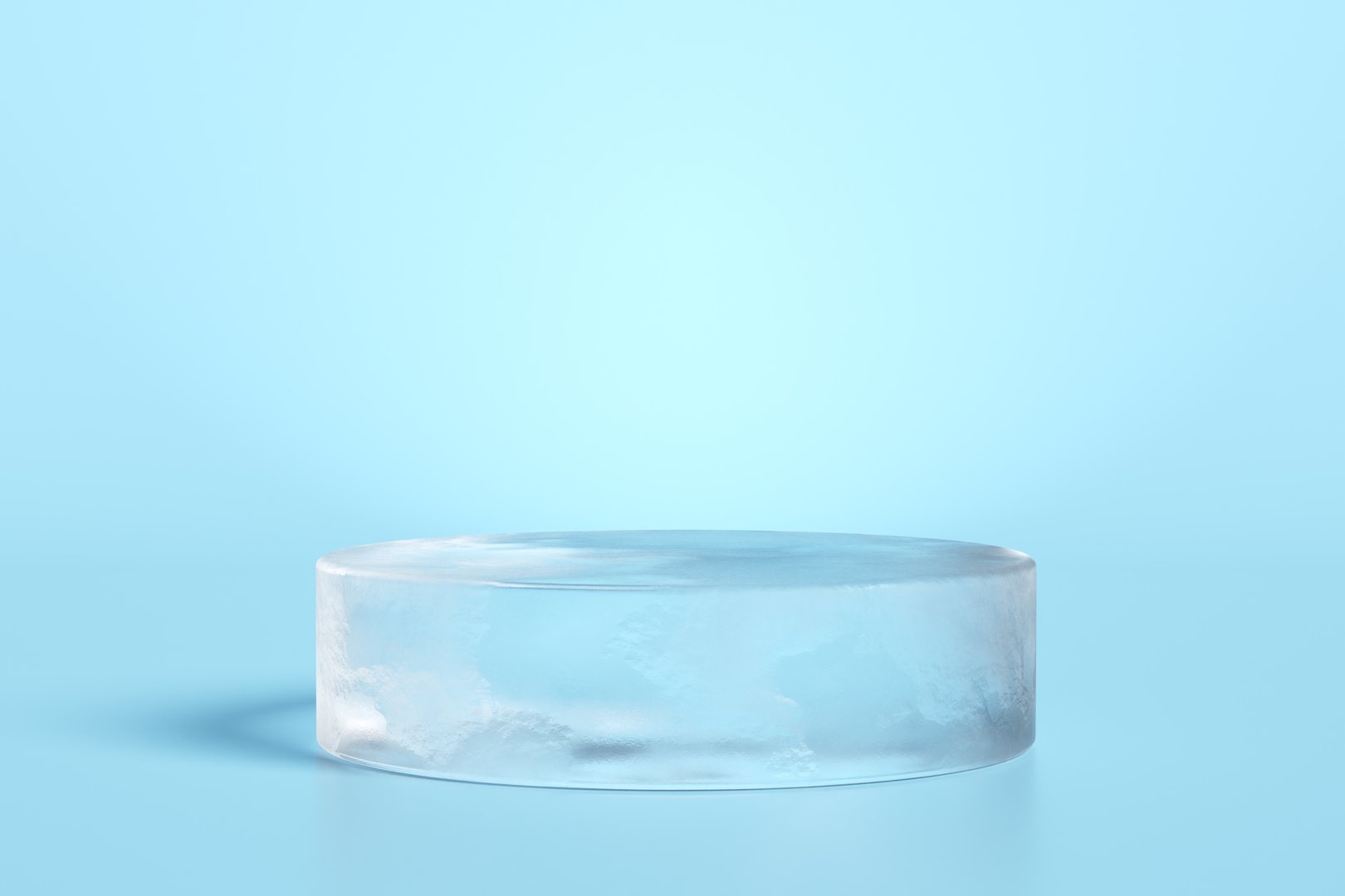 Round ice podium on light blue background ideal for showcasing products related to freshness and coolness