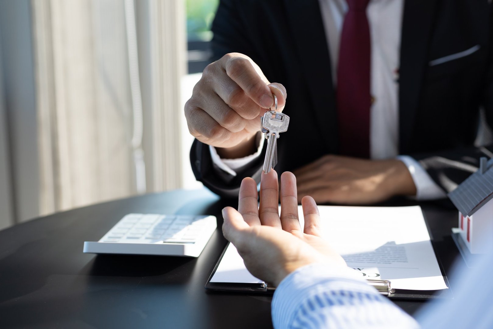 Real estate agent handing keys to client