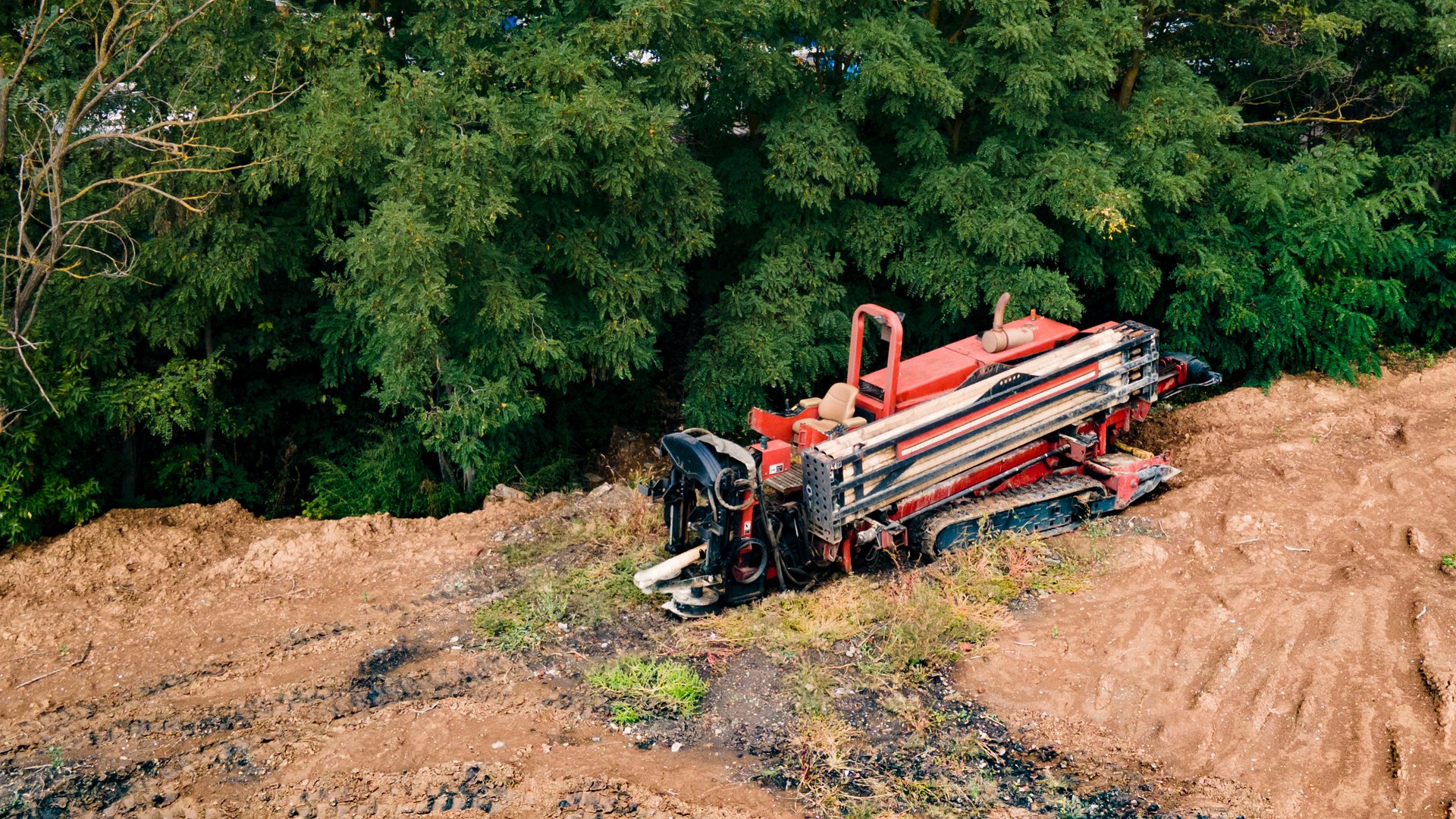 Horizontal directional drilling technology. Aerial view of Drilling machine work process. Trenchless laying of communications, pipes and water pipes