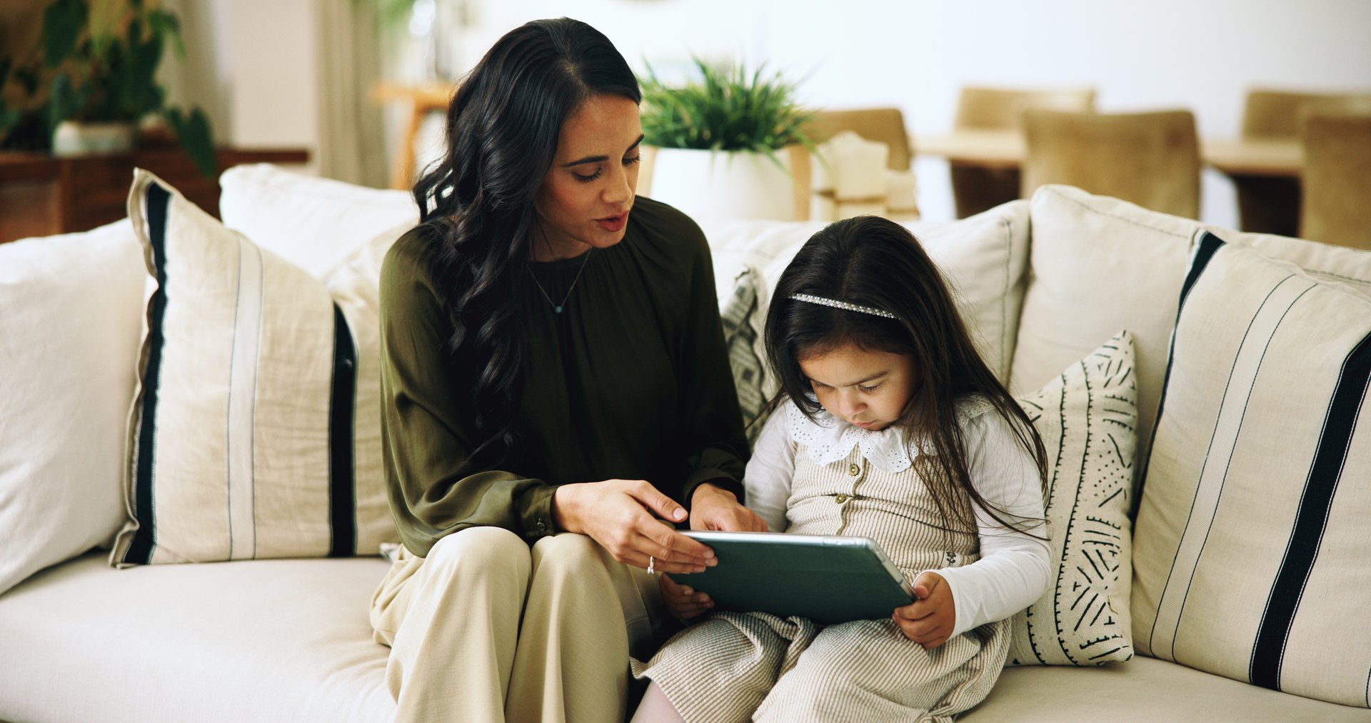 Home, mother or girl with tablet, internet or bonding together with help, ebook or digital app for game. Screen time, mama or daughter in lounge, tech or online safety with entertainment or animation