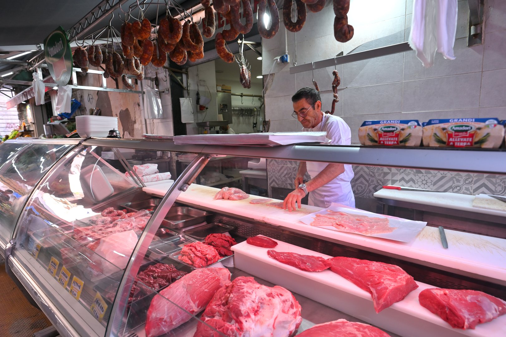 Catania, Italy - October 30, 2023: unidentified people trade meat food in Catania, Italy. This market is also tourist attraction in Catania, Sicily.