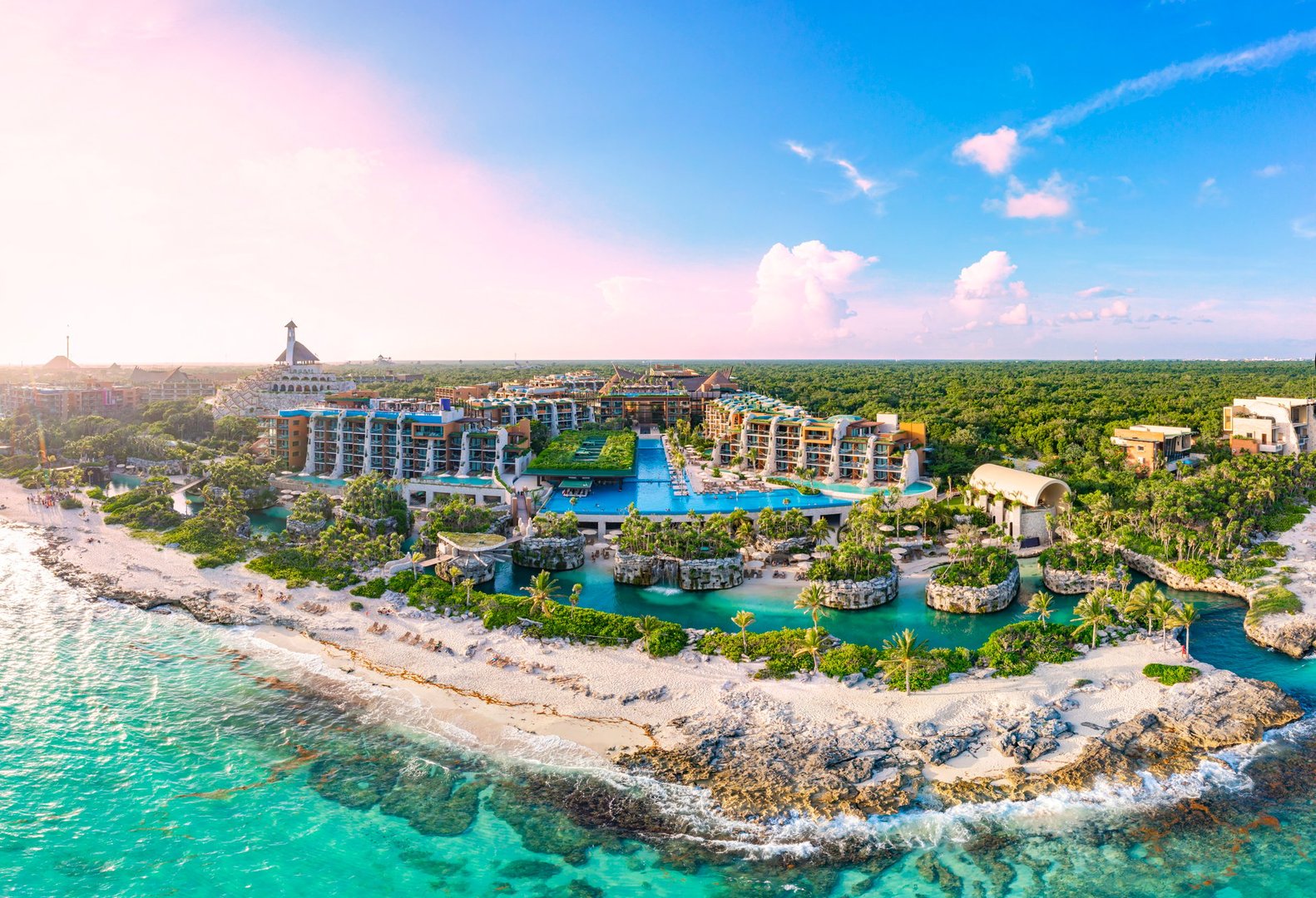 Aerial tour over a luxurious 5-star hotel resort next to the beautiful beaches of Cancun with sunny weather