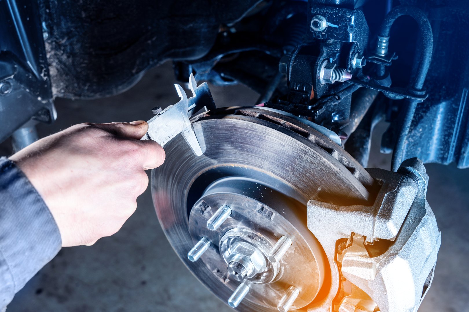 Checking the brake discs wear with calipers.