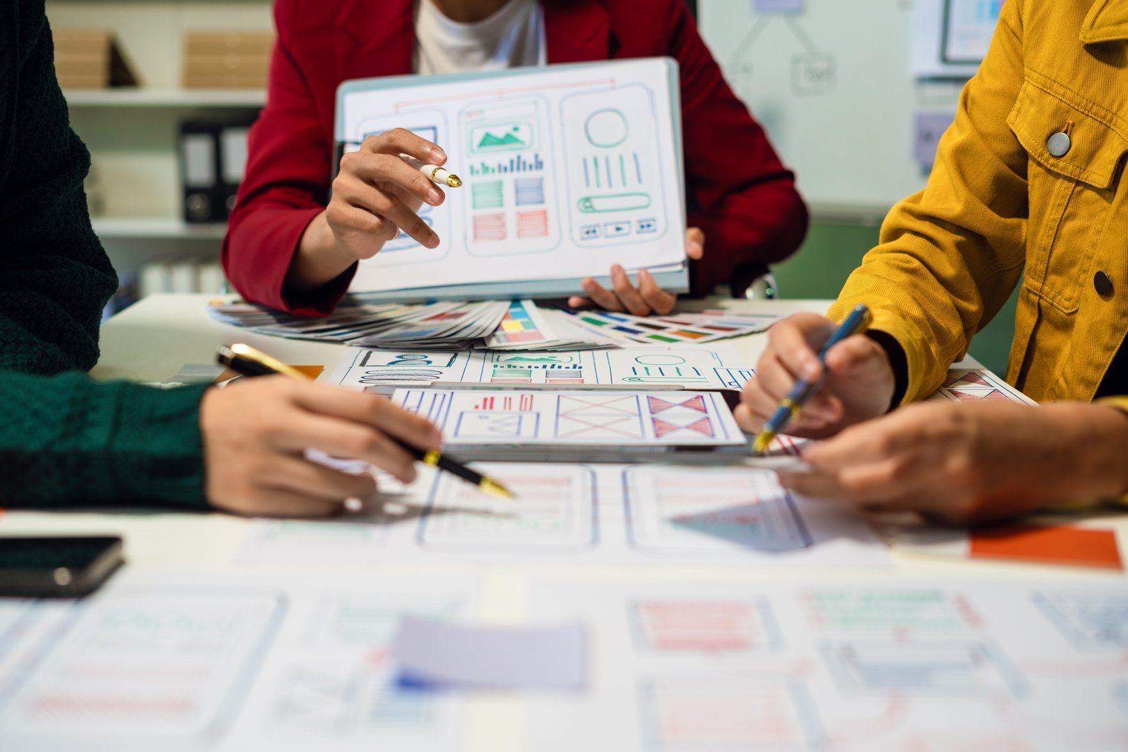 UX developer and ui designer brainstorming about mobile app interface wireframe design with customer breif and color code, User experience concept