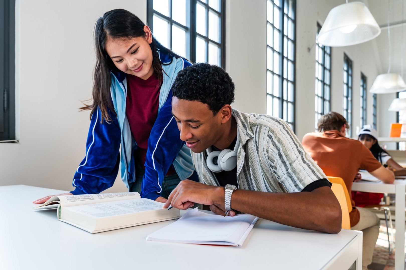 Students studying together in library