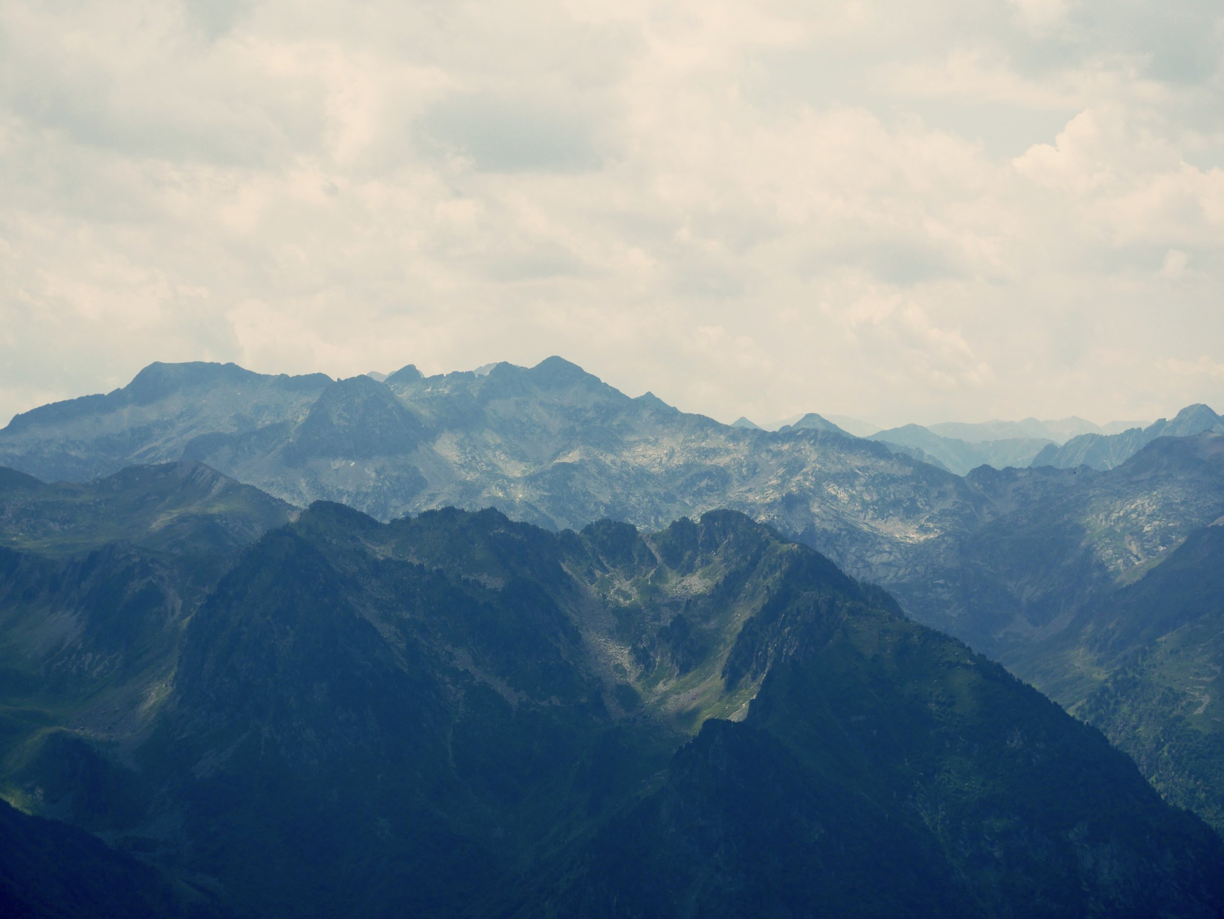 mountain landscape with dark green peaks and cloudy sky