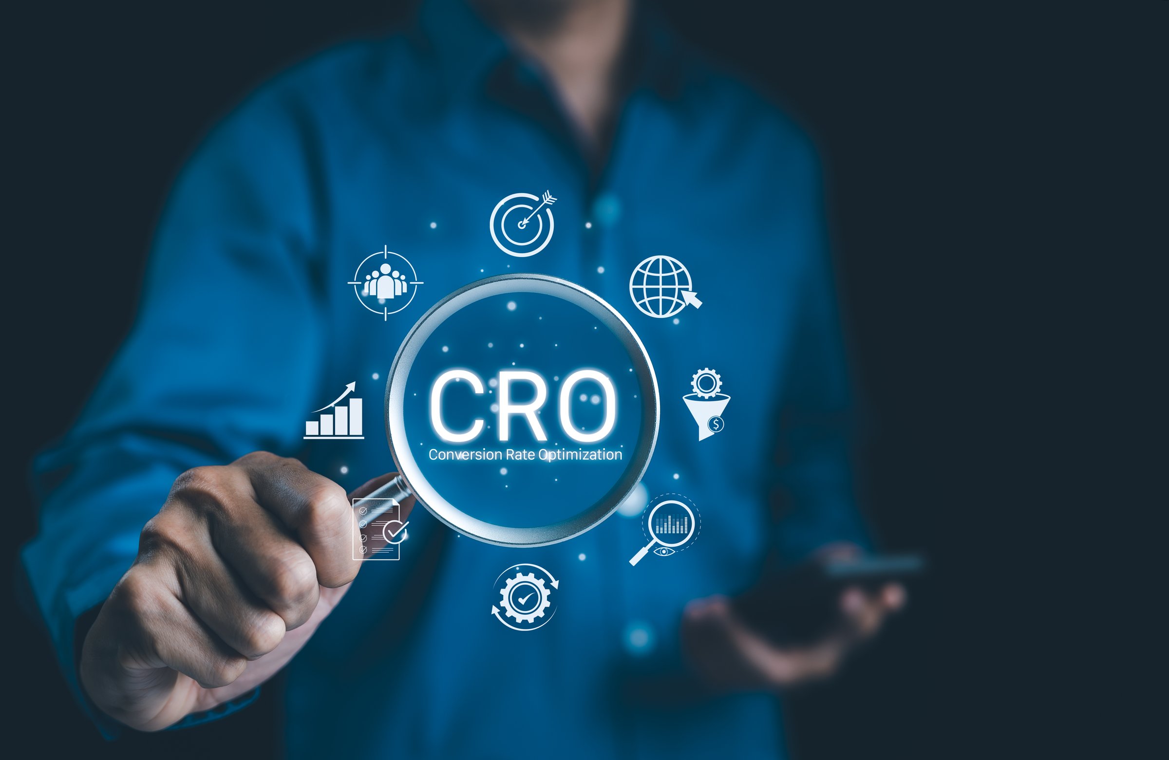 CRO, Conversion Rate Optimization Concept. Businessman holding magnifying glass focusing on the text CRO with digital icons representing conversion rate optimization strategies. Business strategy,