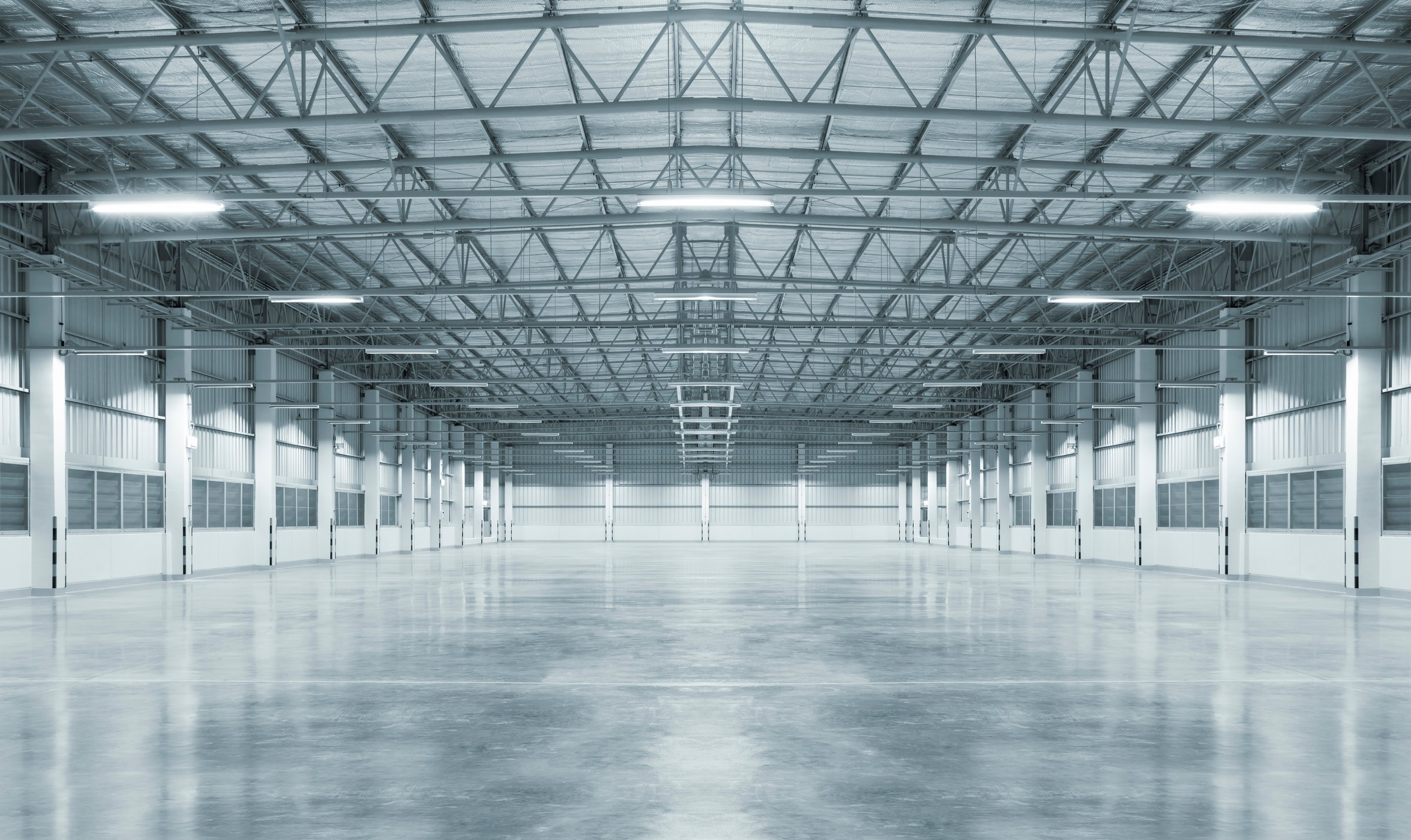 Empty factory with concrete floor, night scene.
