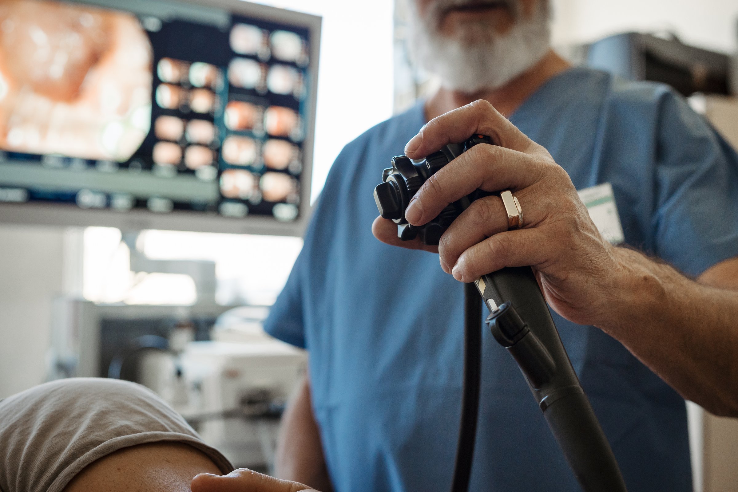 Doctor looking at monitior during gastroscopy procedure, examining upper digestive tract. Medical procedure.