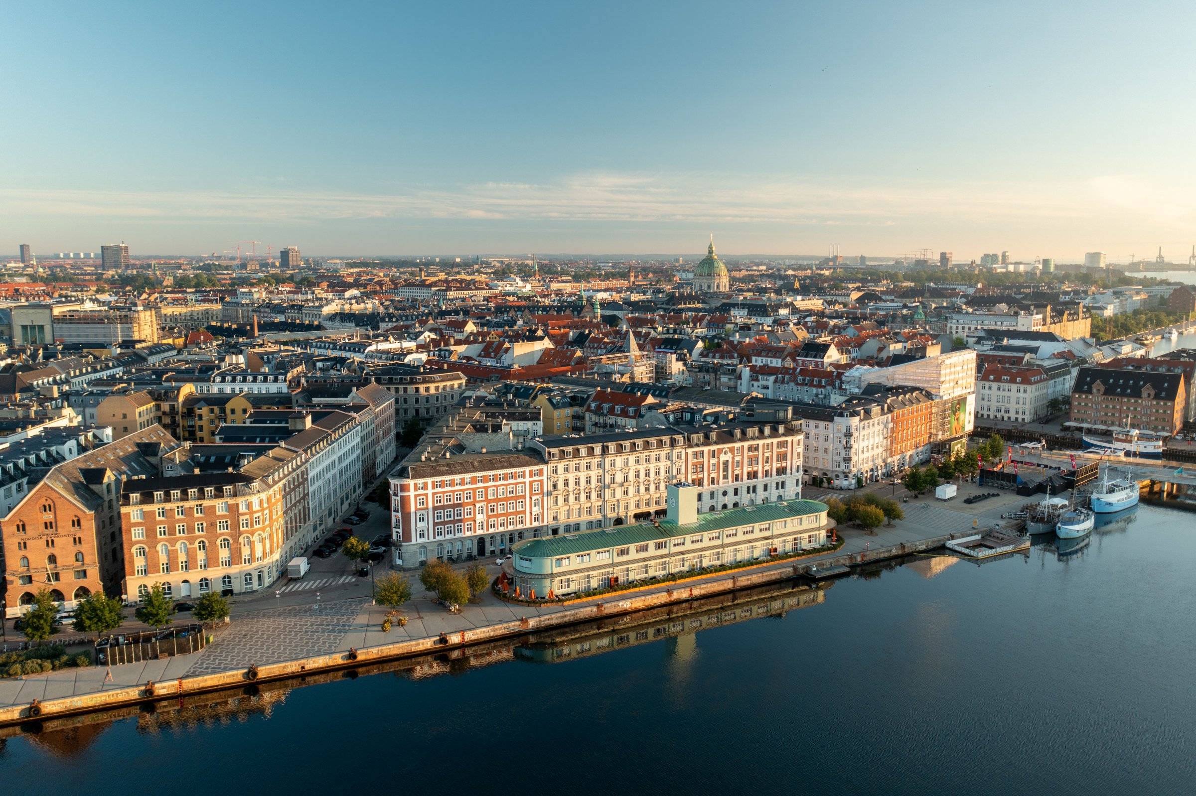 Drone view of Copenhagen waterfront and Marble Church at sunrise.