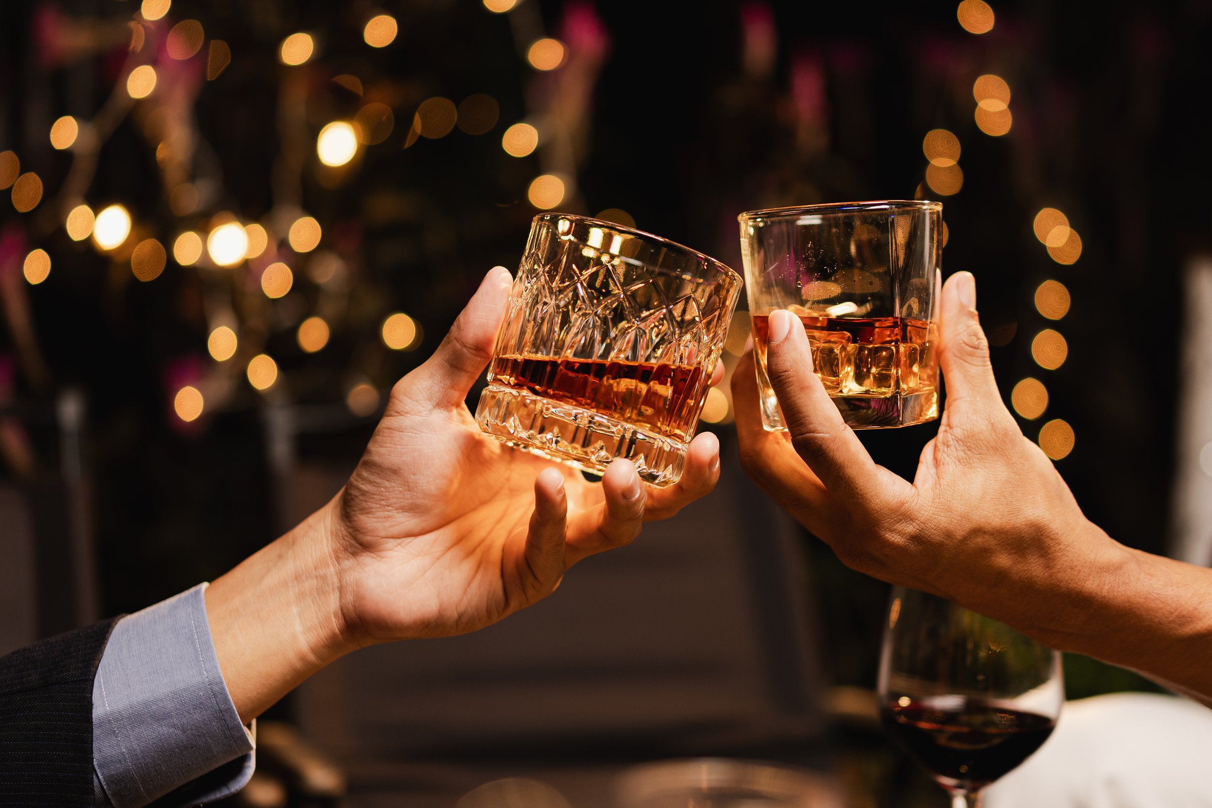 Happy two man clinking glasses of whiskey in celebration, Holiday, Festival celebration, Friendship and celebration concept.
