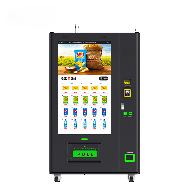 Black vending machine with a digital screen displaying snack options and payment icons, featuring a PULL door.