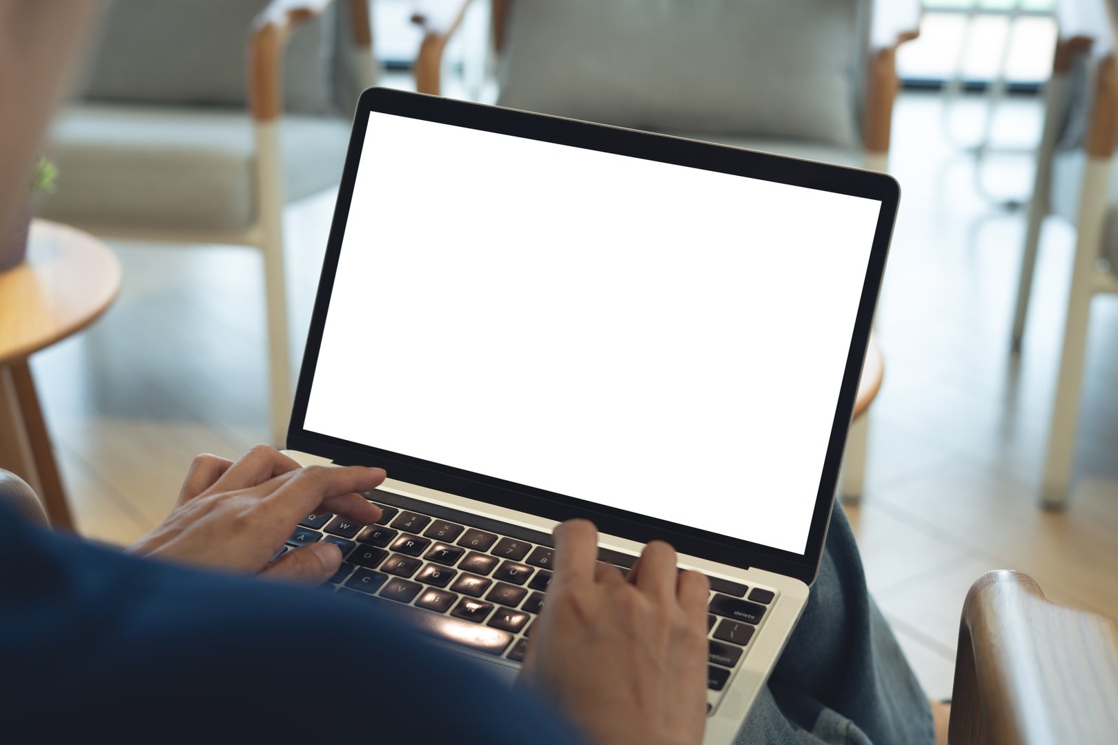 Mockup laptop with blank white screen. Young woman using laptop computer, working at coffee shop, empty screen, remote work, web template, for social media marketing, rear view