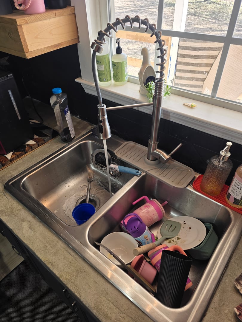 Kitchen sink before cleaning - showing dirty and stained sink