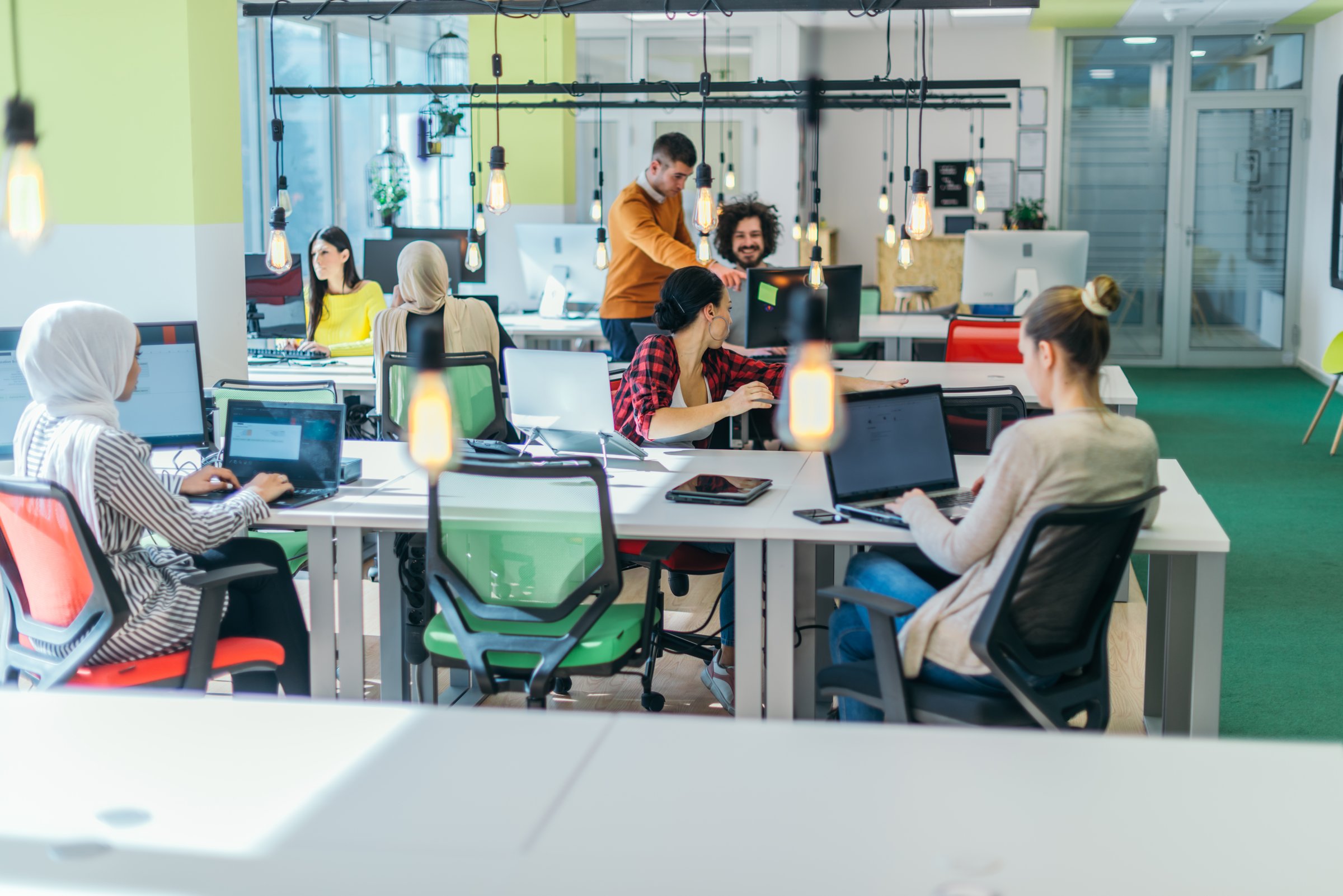Successful team. Group of young business people working and communicating together in creative office