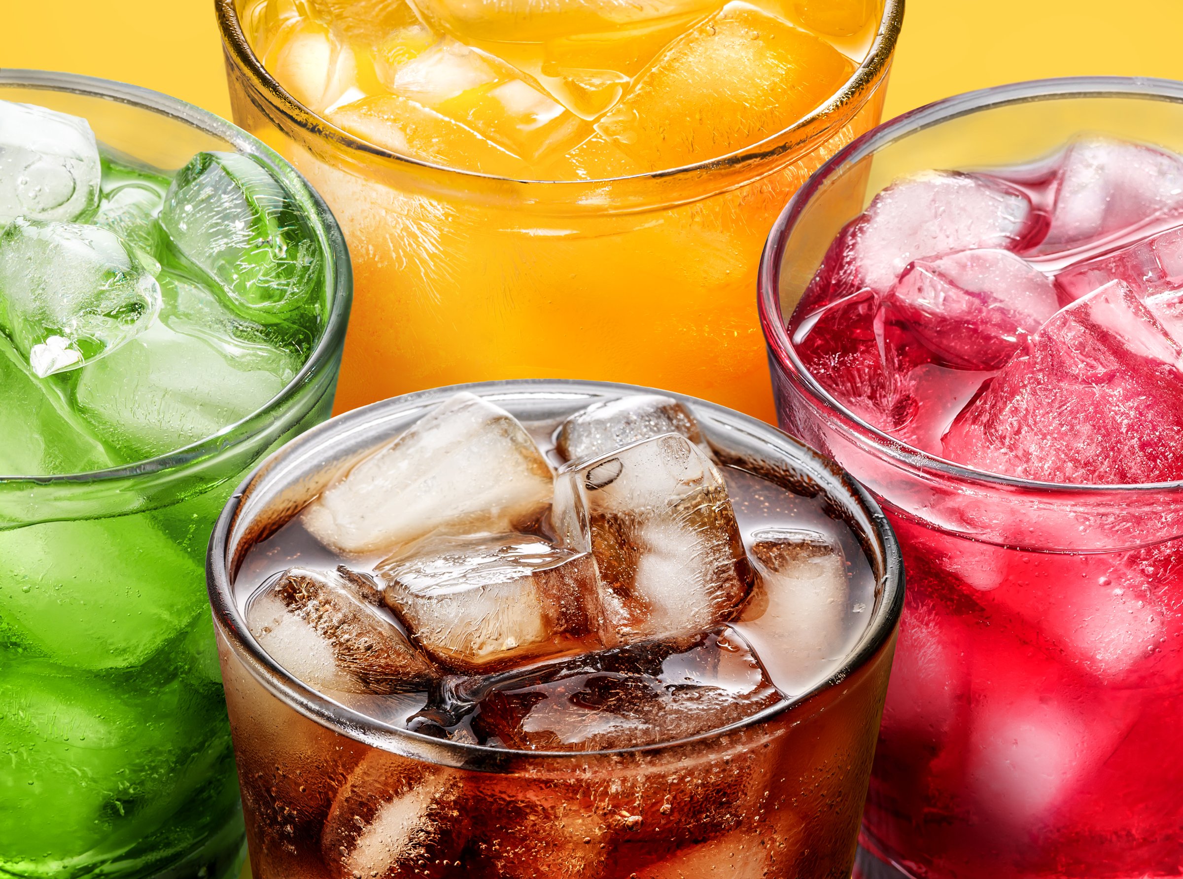 The colorful assortment of cold drinks with ice cubes is perfect for refreshing summer drinks at a party and quenching thirst.