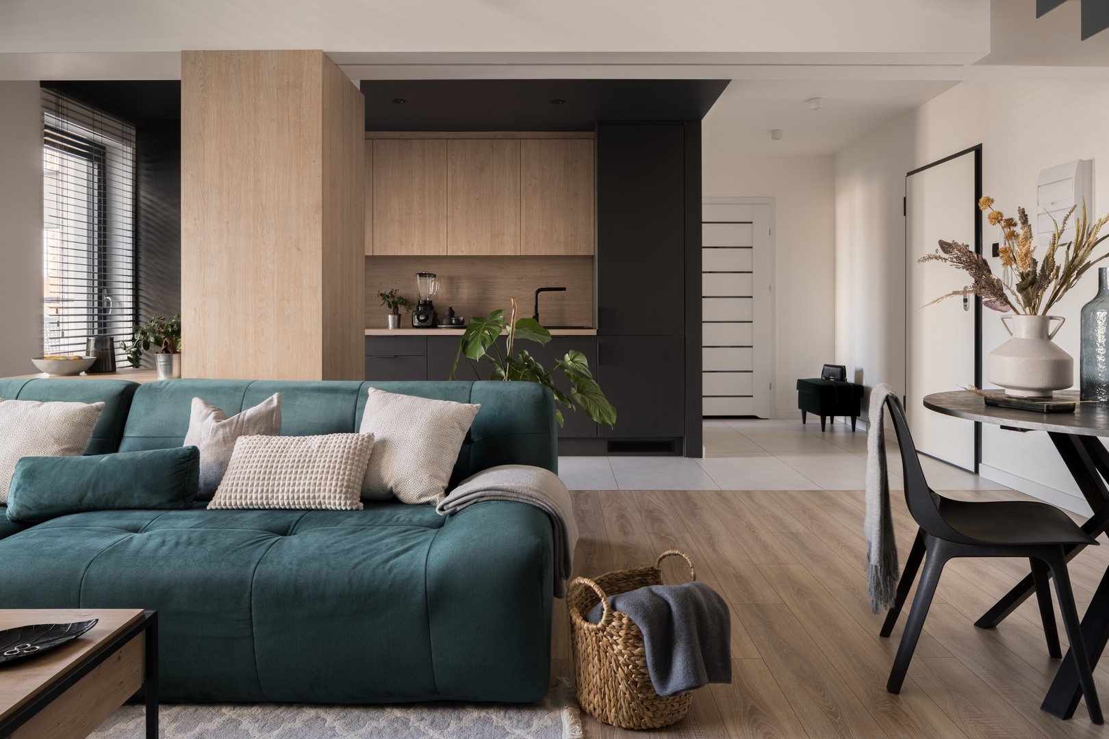 Modern open plan apartment with stylish living room with dining area and simple kitchen in one room