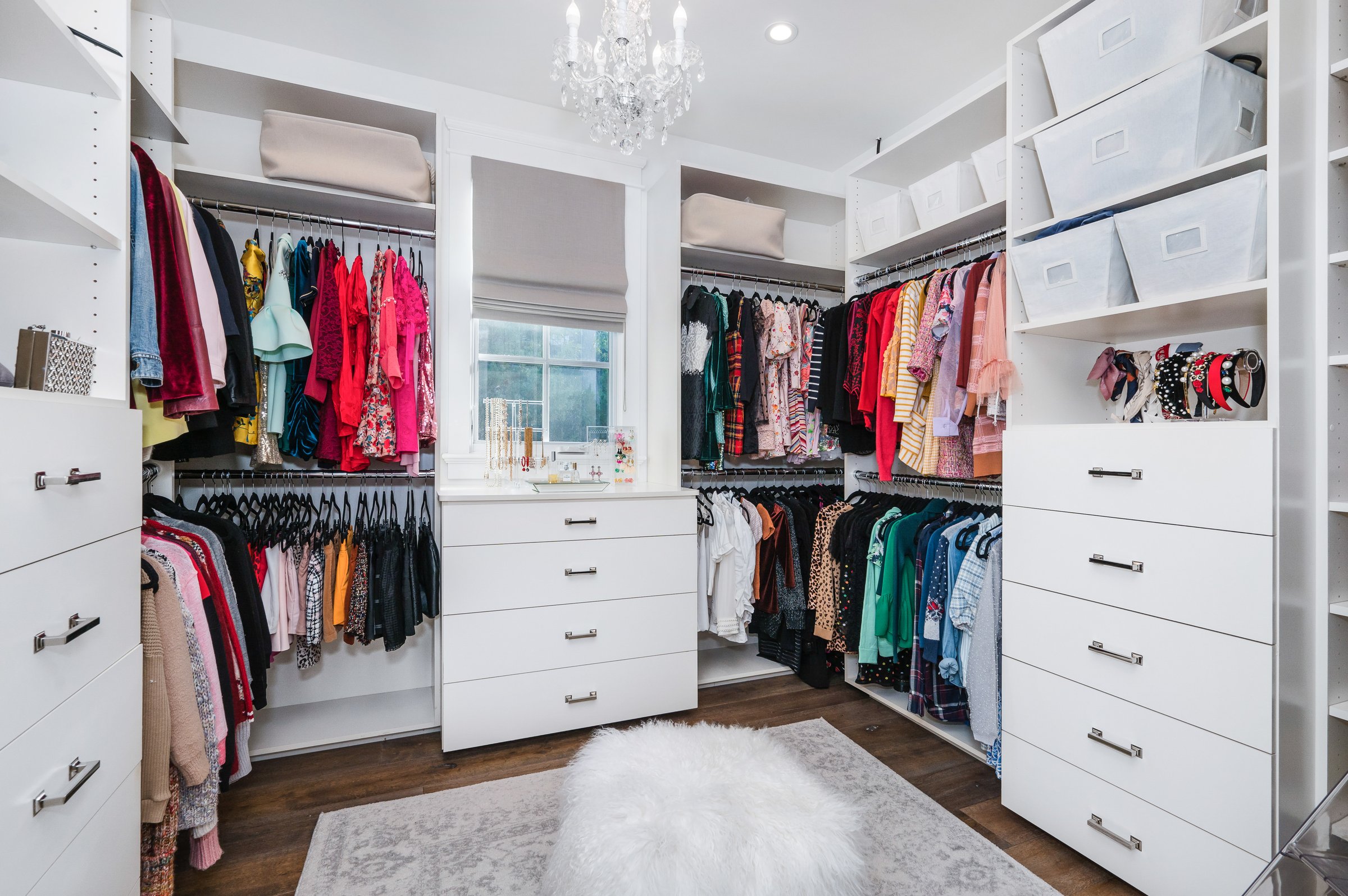 Bright feminine organized closet with clothing
