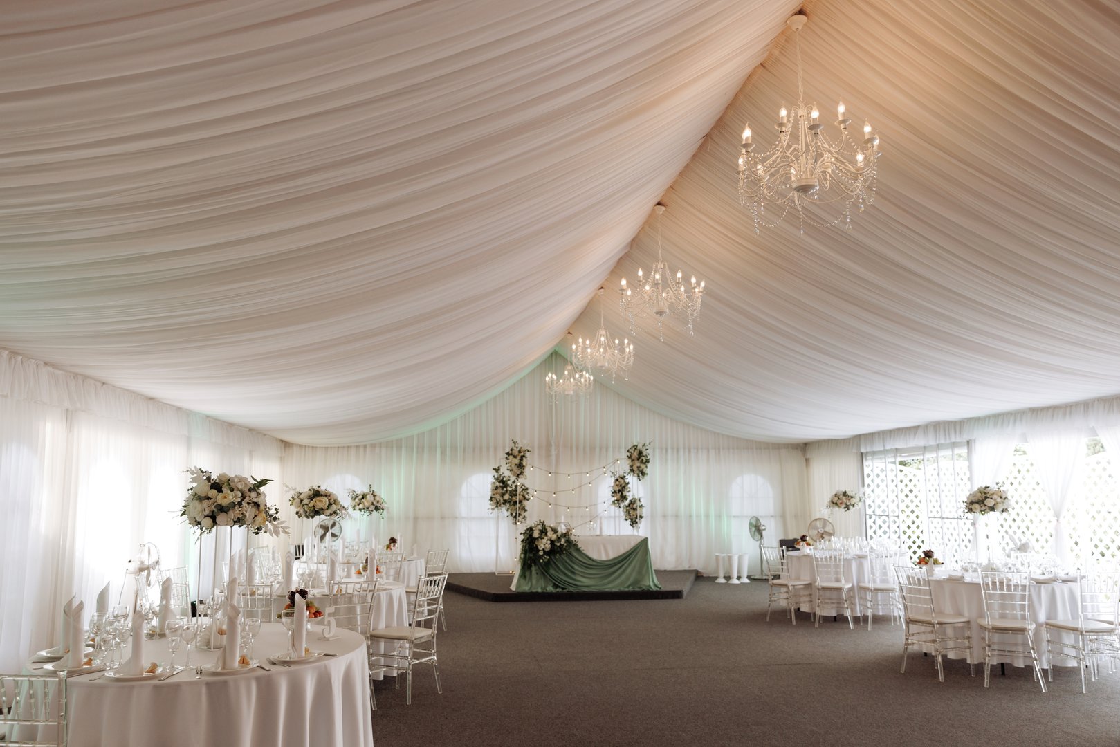 A view inside a marquee set up for a wedding reception. High quality photo