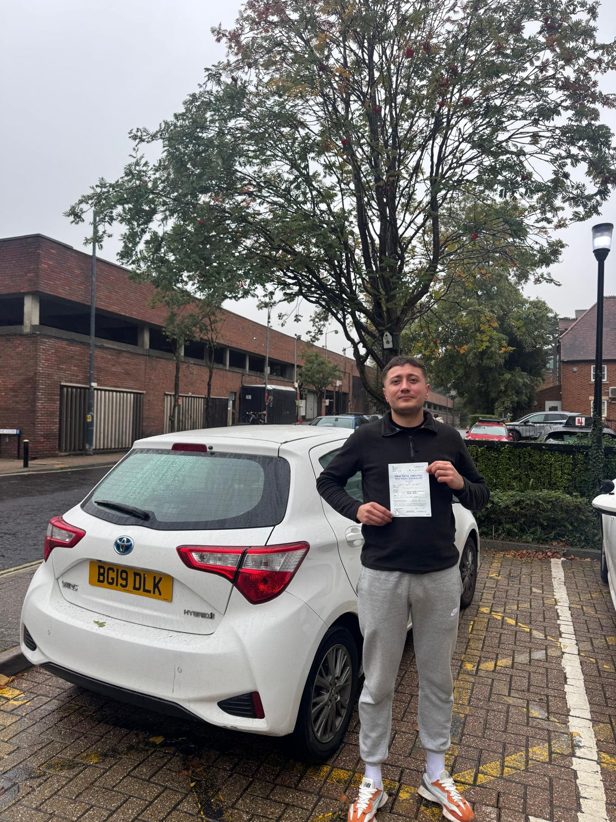 Successful driving test student with pass certificate