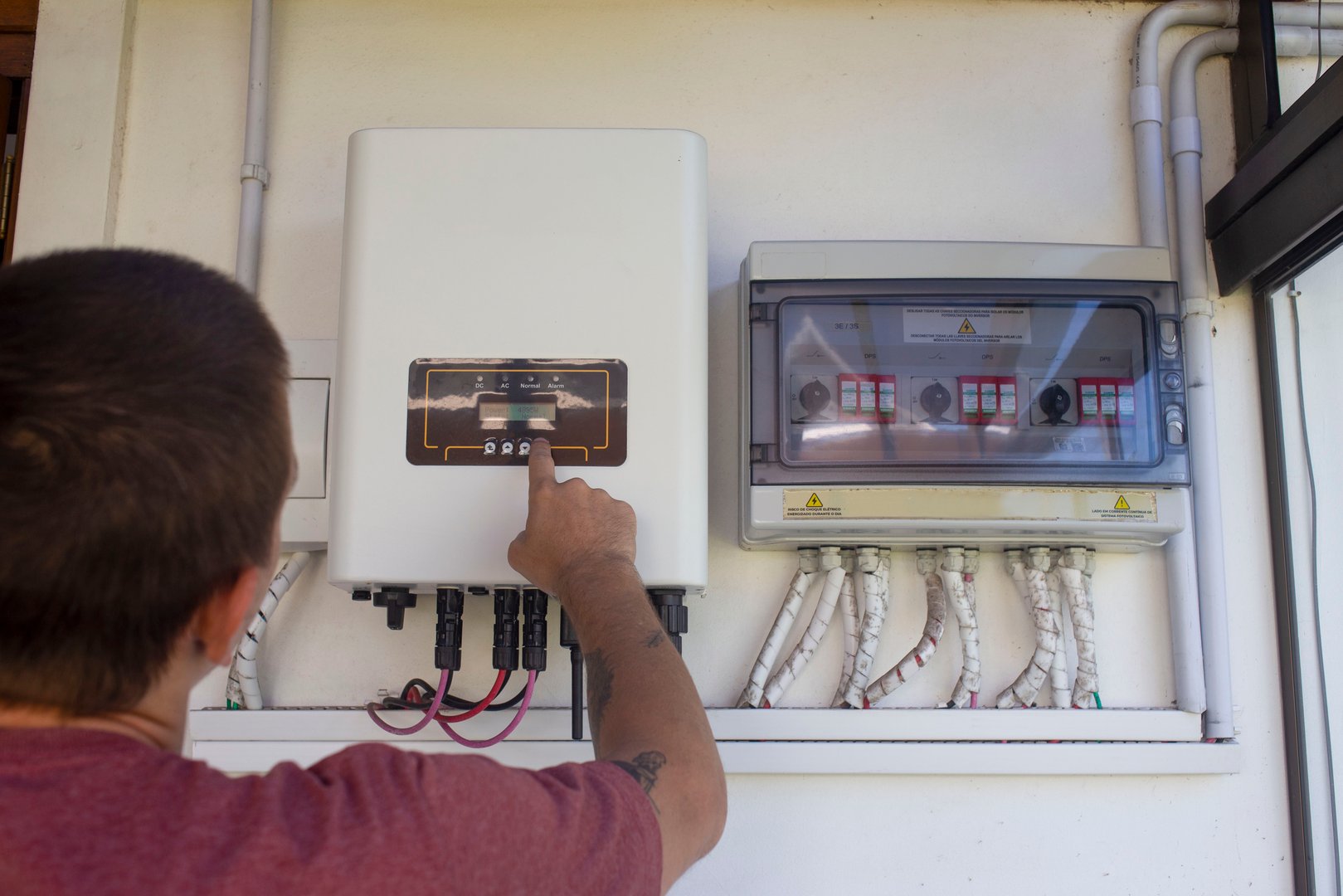 Man setting up solar energy system control panel