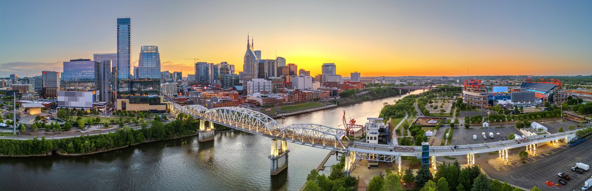 Nashville, Tennessee, USA skyline over the Cumberland River at sunset.