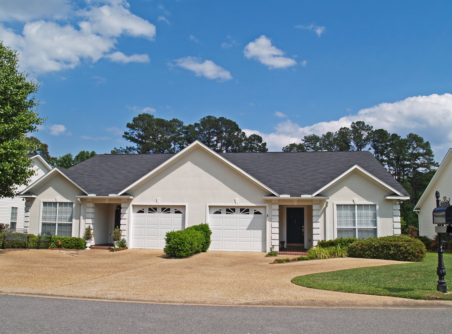 Thomasville, Georgia, USA – April 27, 2010:  New low income small one story white vinyl duplex unit with garages in the front.