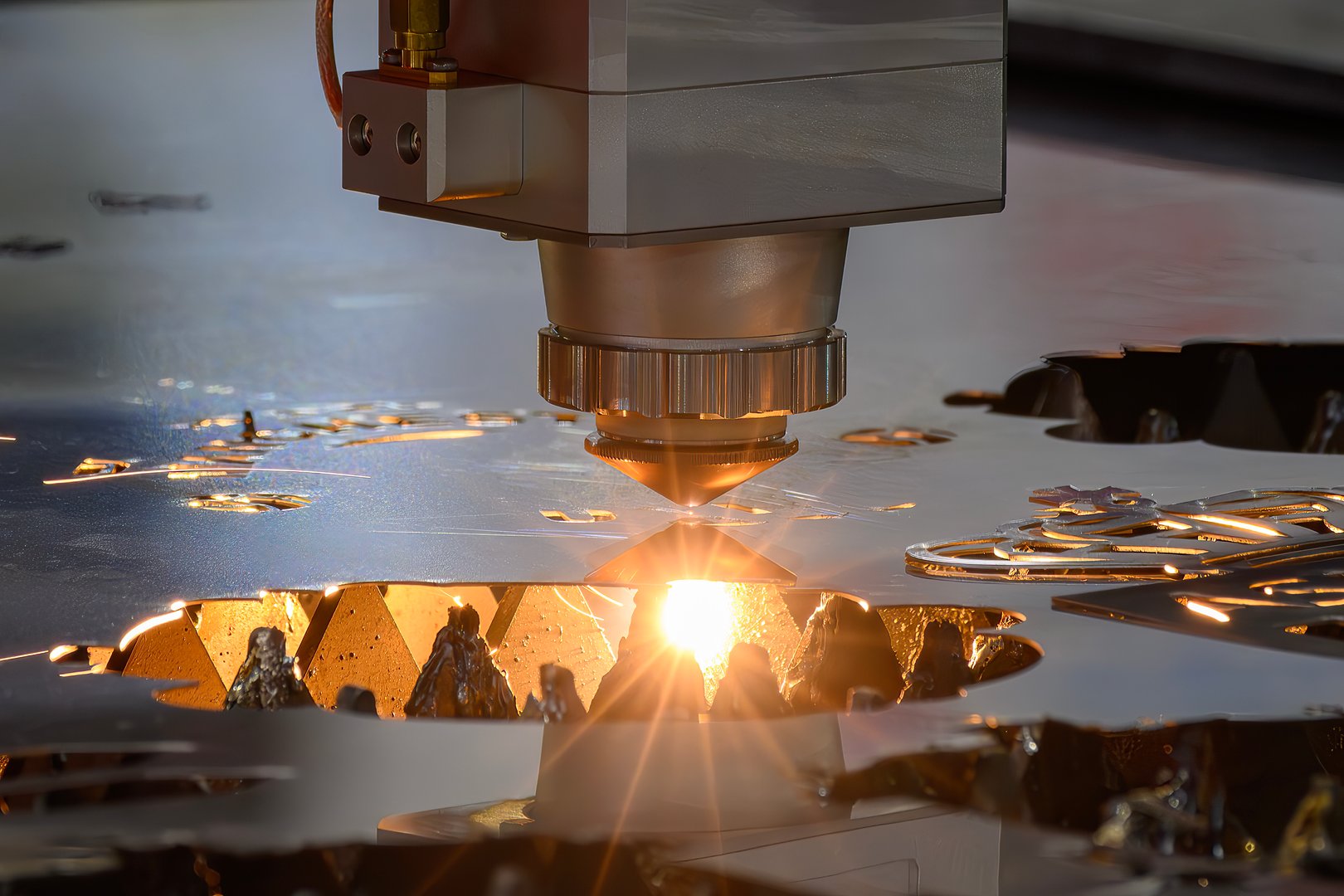 The fiber laser cutting machine  cut the metal plate with the sparkling light. The hi-technology sheet metal manufacturing process by laser cutting machine.