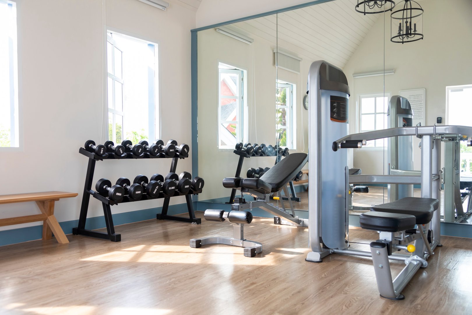 Fitness club interior and many equipments with wood floor and blue wall.