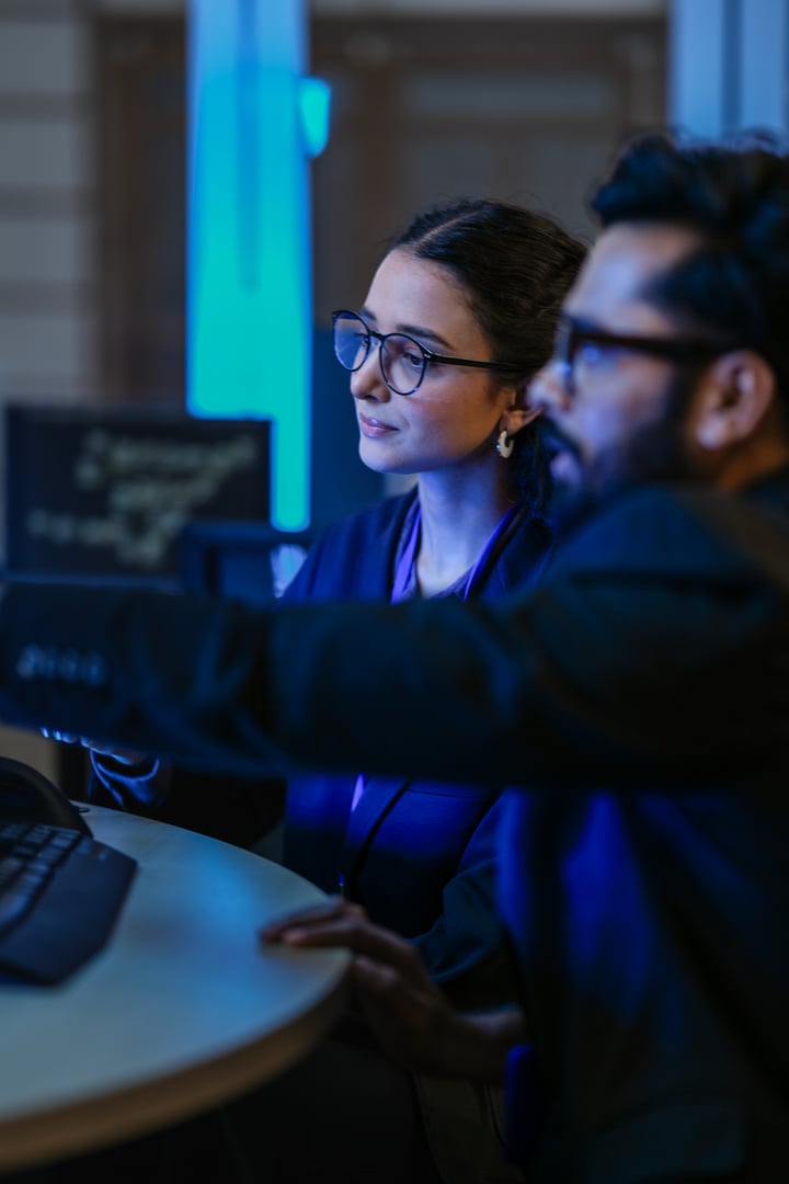 A diverse team of AI developers shares a successful moment in the office.