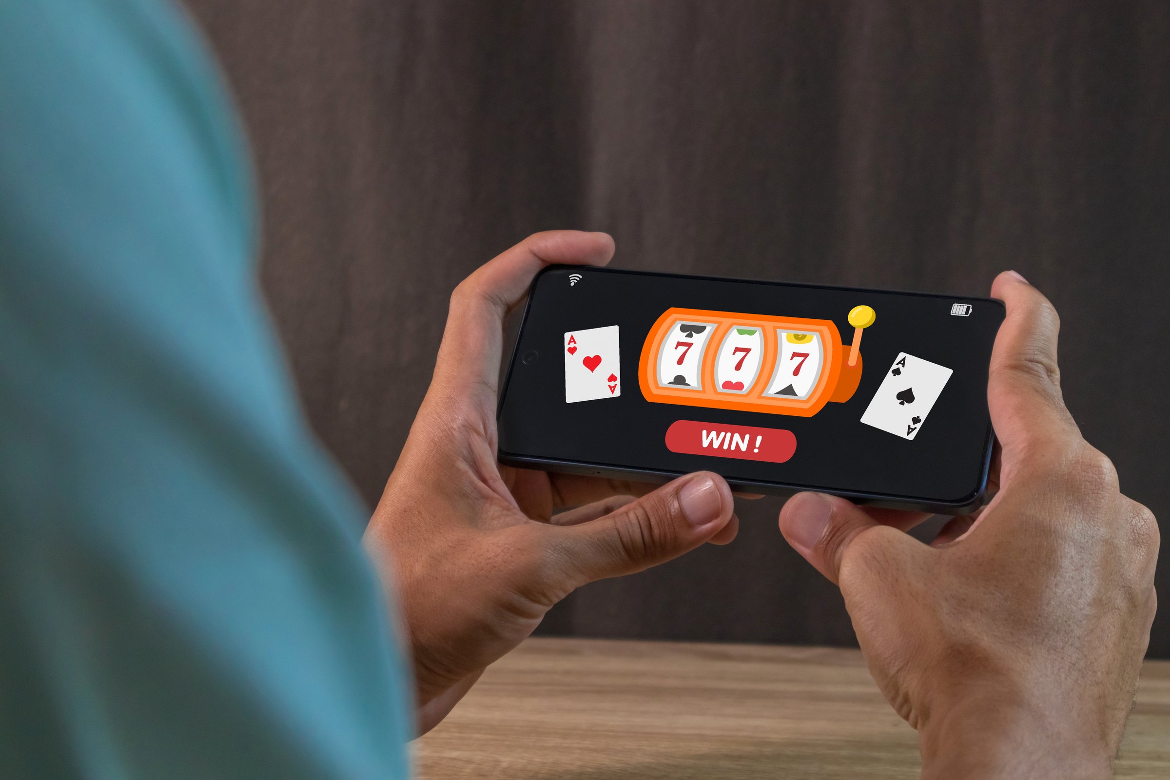 Man winning jackpot on online casino app on a smartphone. Online casino gambling concept.