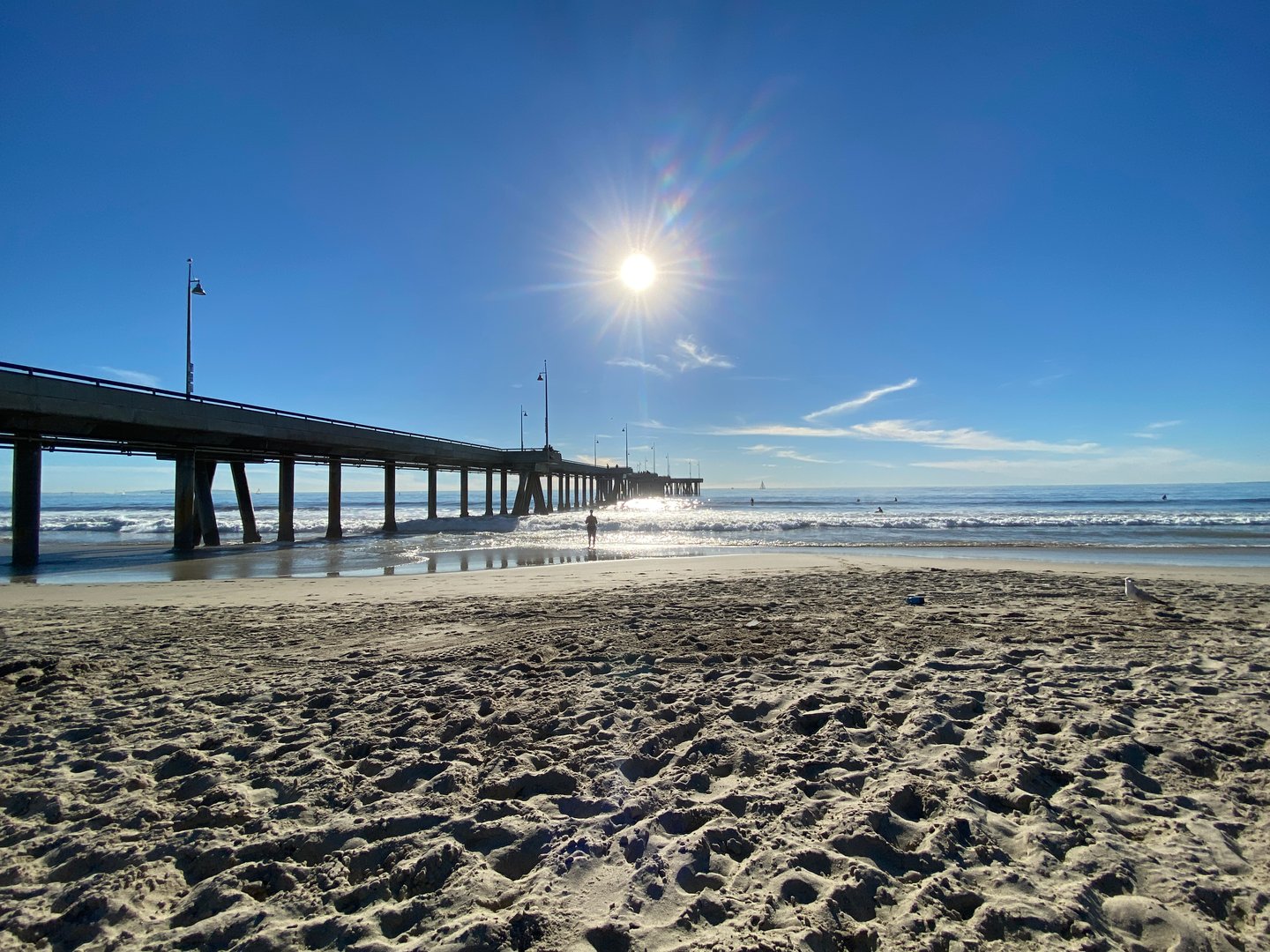 Wide view of Venice Beach Pier and Pacific Ocean on a bright sunny day in Venice Beach, Los Angeles