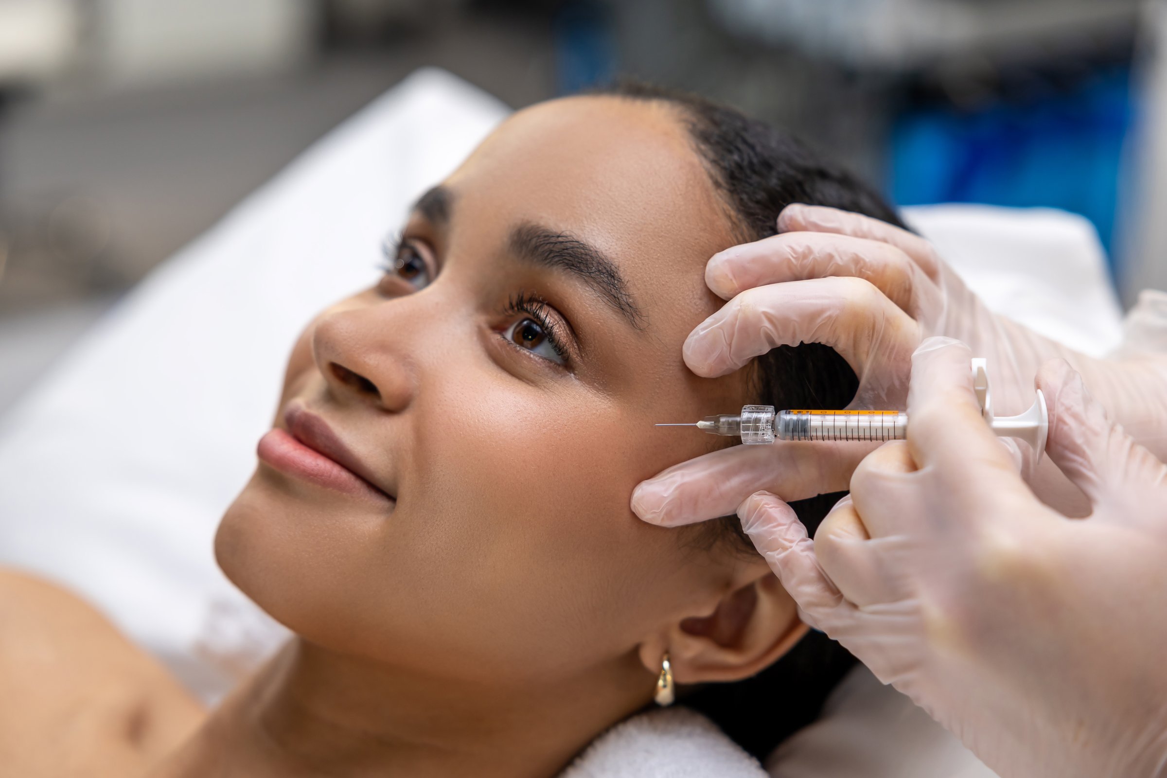 Mesotherapy. Young dark-skinned woman having a session of mesotherapy