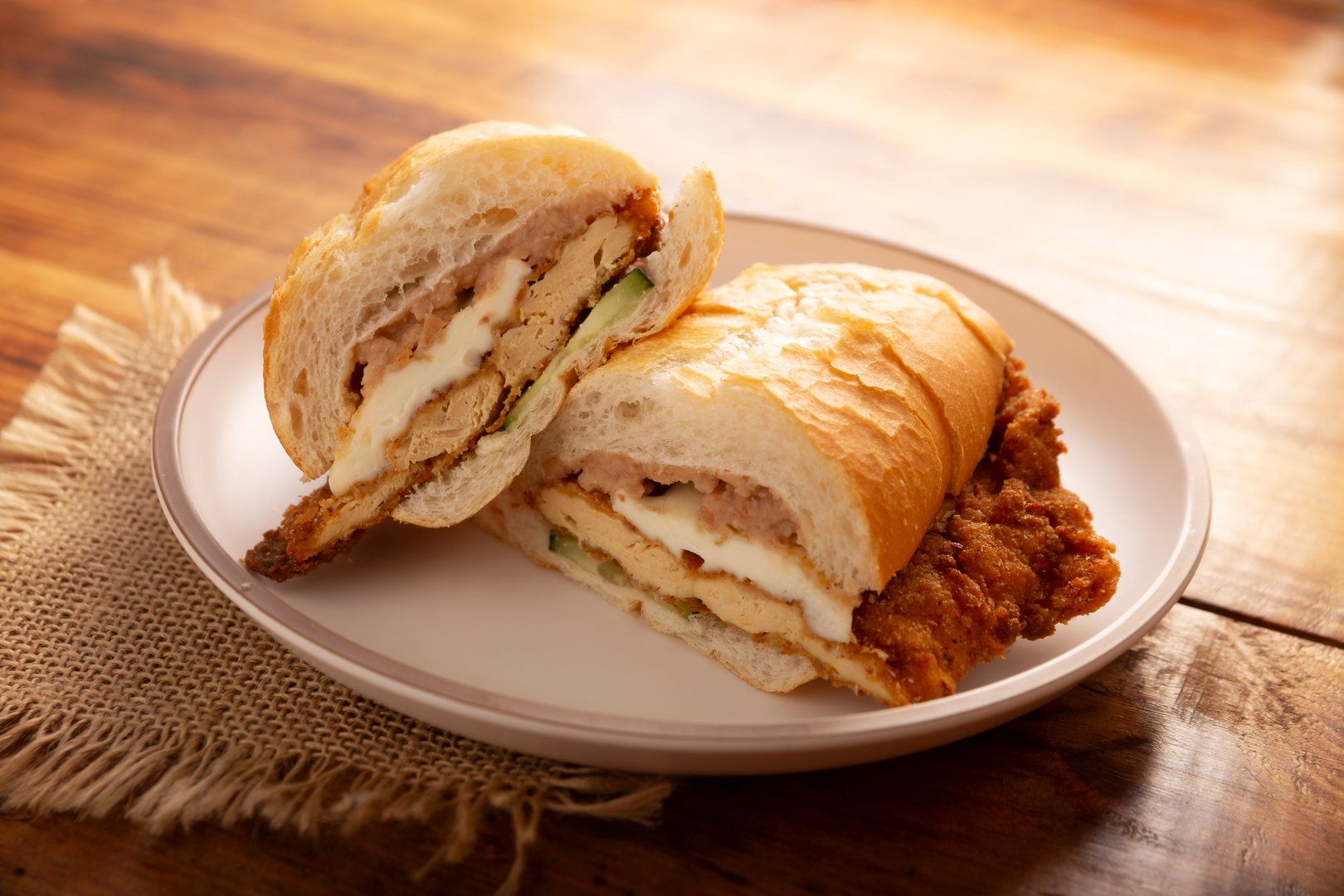 Mexican Torta de Milanesa. Sandwich made with bolillo bread, telera or baguette, split in half and filled with various ingredients, in this case breaded chicken meat with Oaxaca cheese.