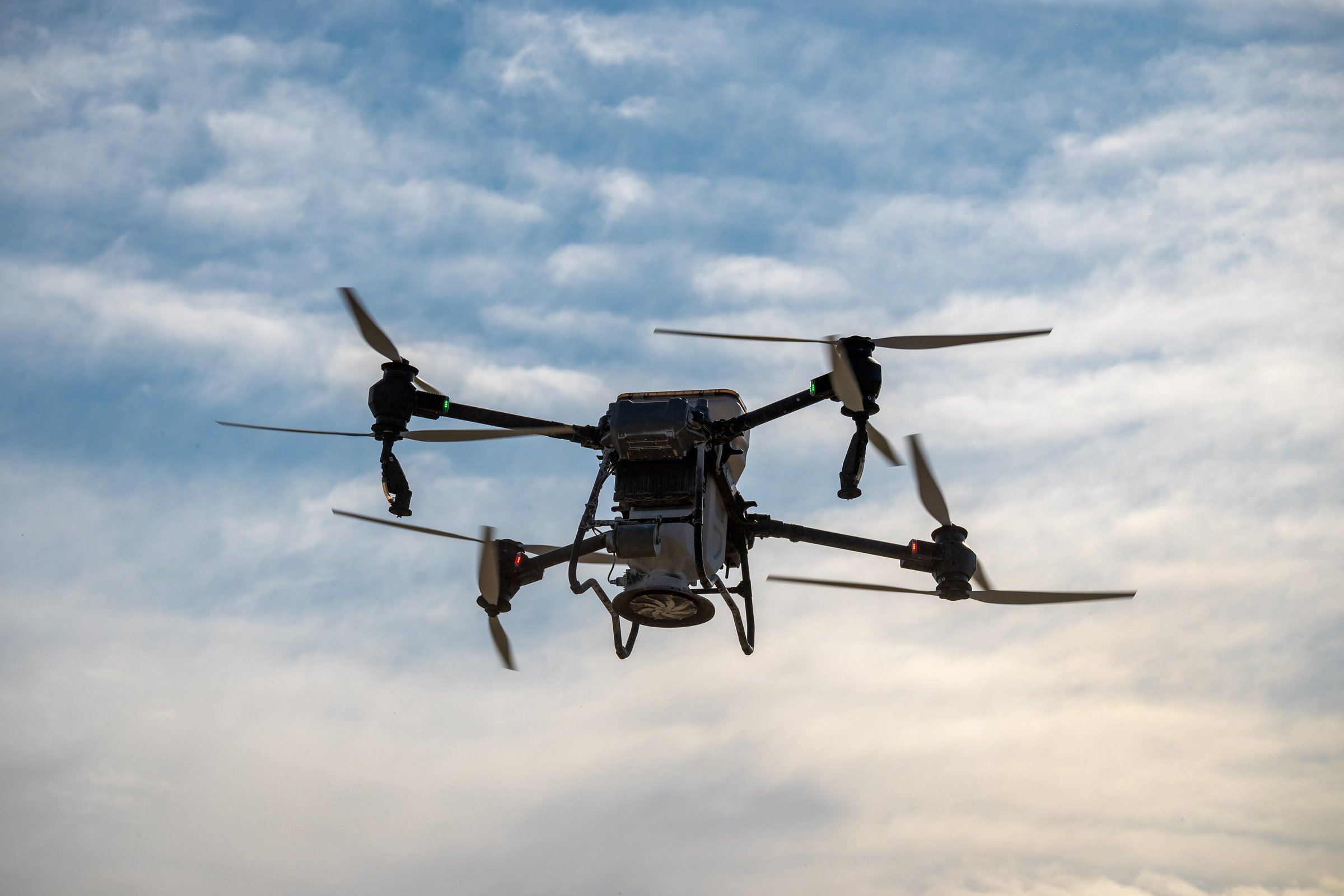 San Rafael, Argentina, October 1, 2024; Large agricultural drone in flight, fertilizing a sown field.