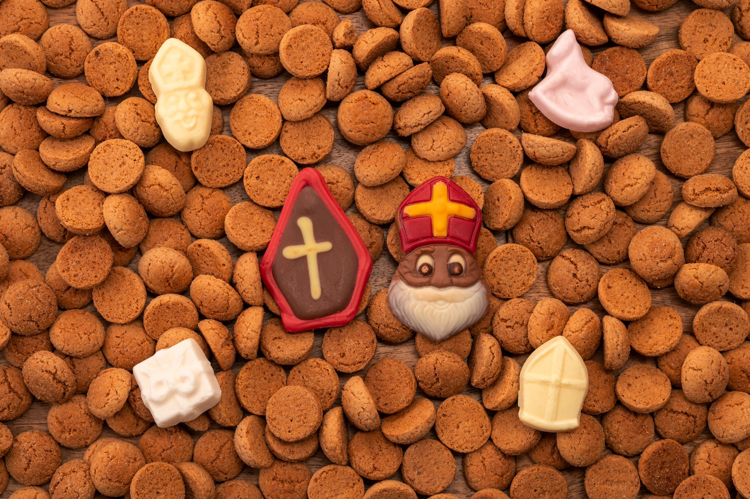 Background Dutch holiday Sinterklaas with copy space for text. Kruidnoten cookies and traditional hollands sweets. Concept for children party Saint Nicolas day five december. Top view.